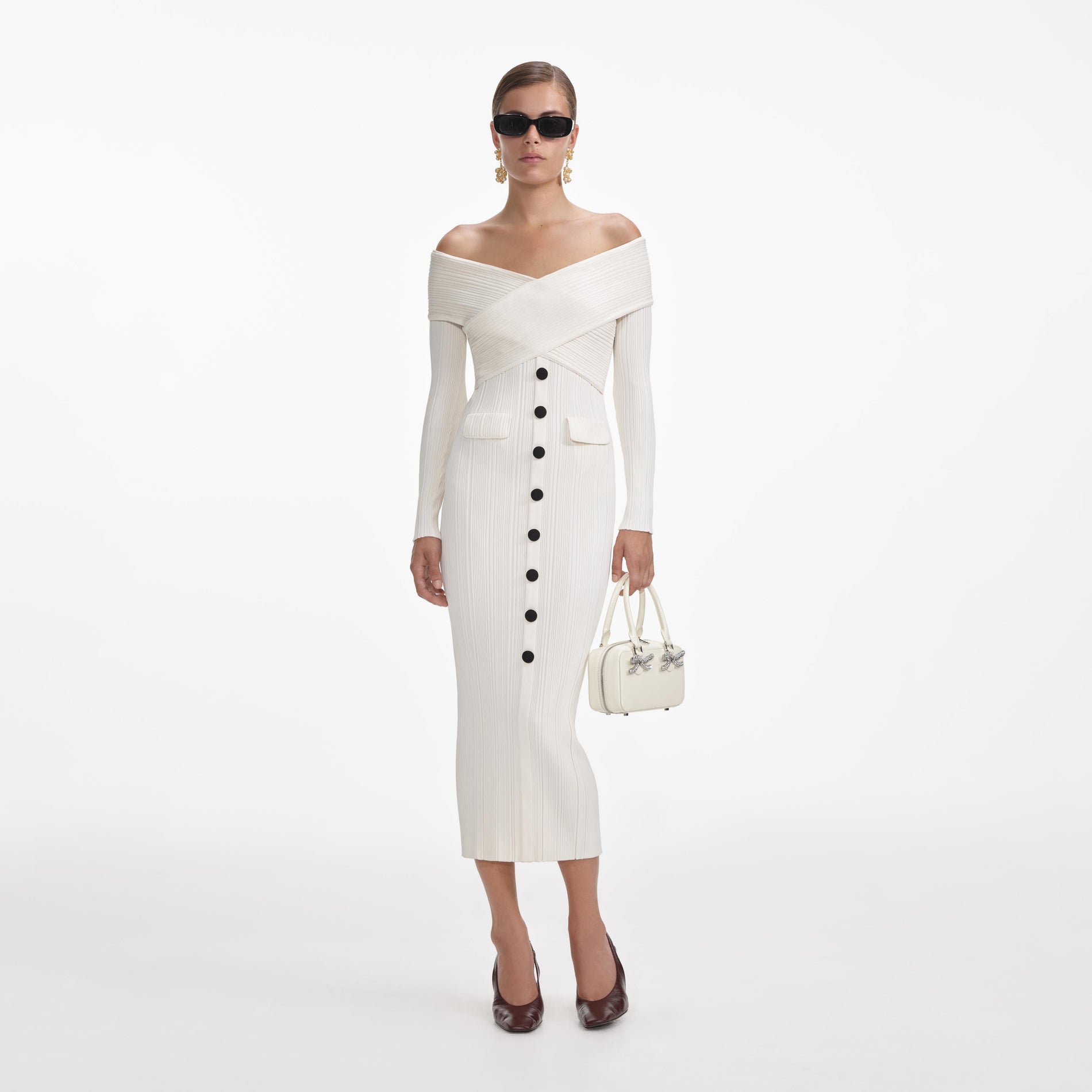 Front view of a woman wearing the Cream Off Shoulder Knit Midi Dress