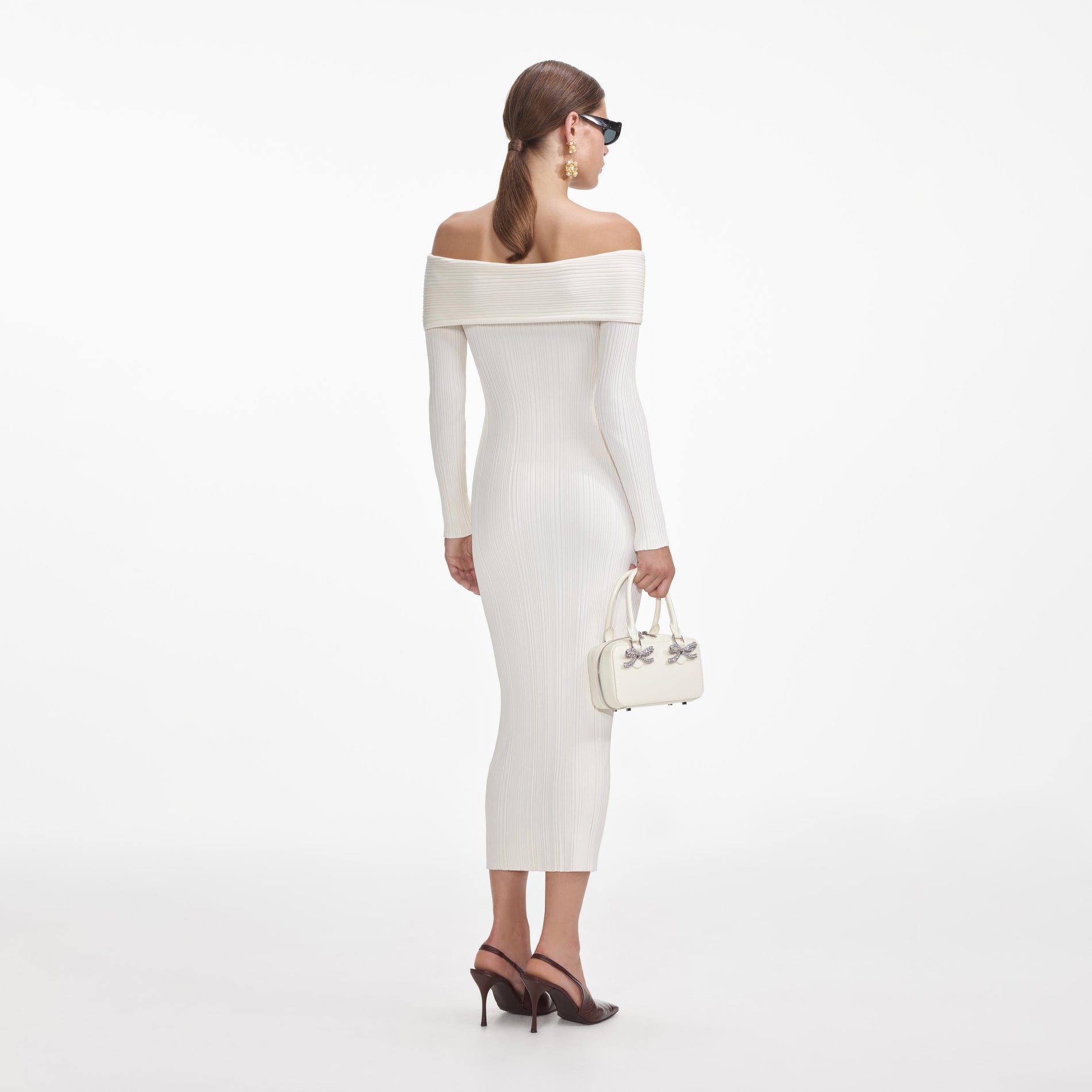 Back view of a woman wearing the Cream Off Shoulder Knit Midi Dress