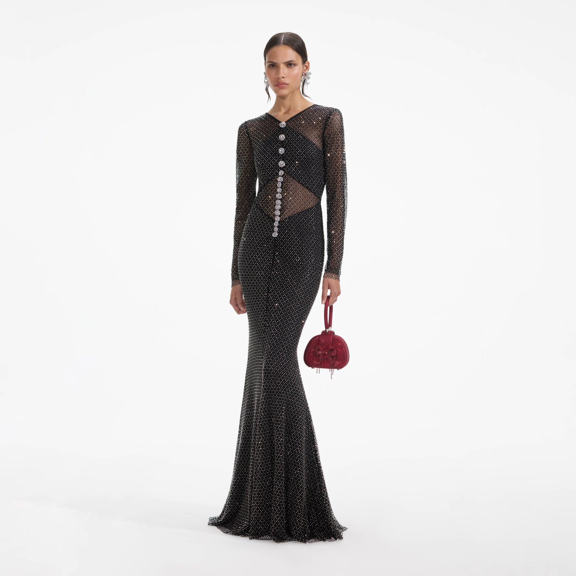 Side view of a woman wearing the Black Rhinestone Fishnet Crossover Maxi Dress