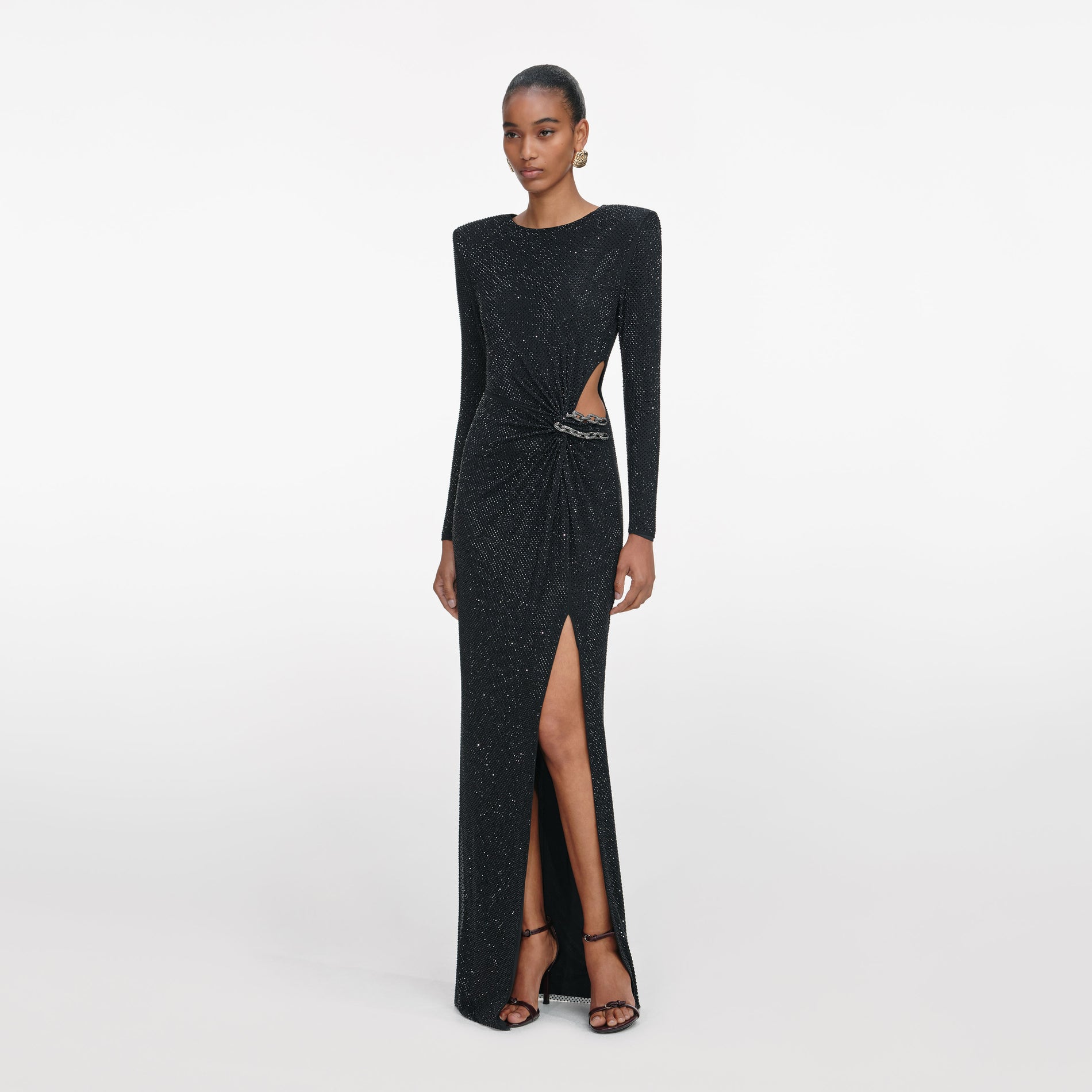 Side view of a woman wearing the Black Rhinestone Embellished Maxi Dress