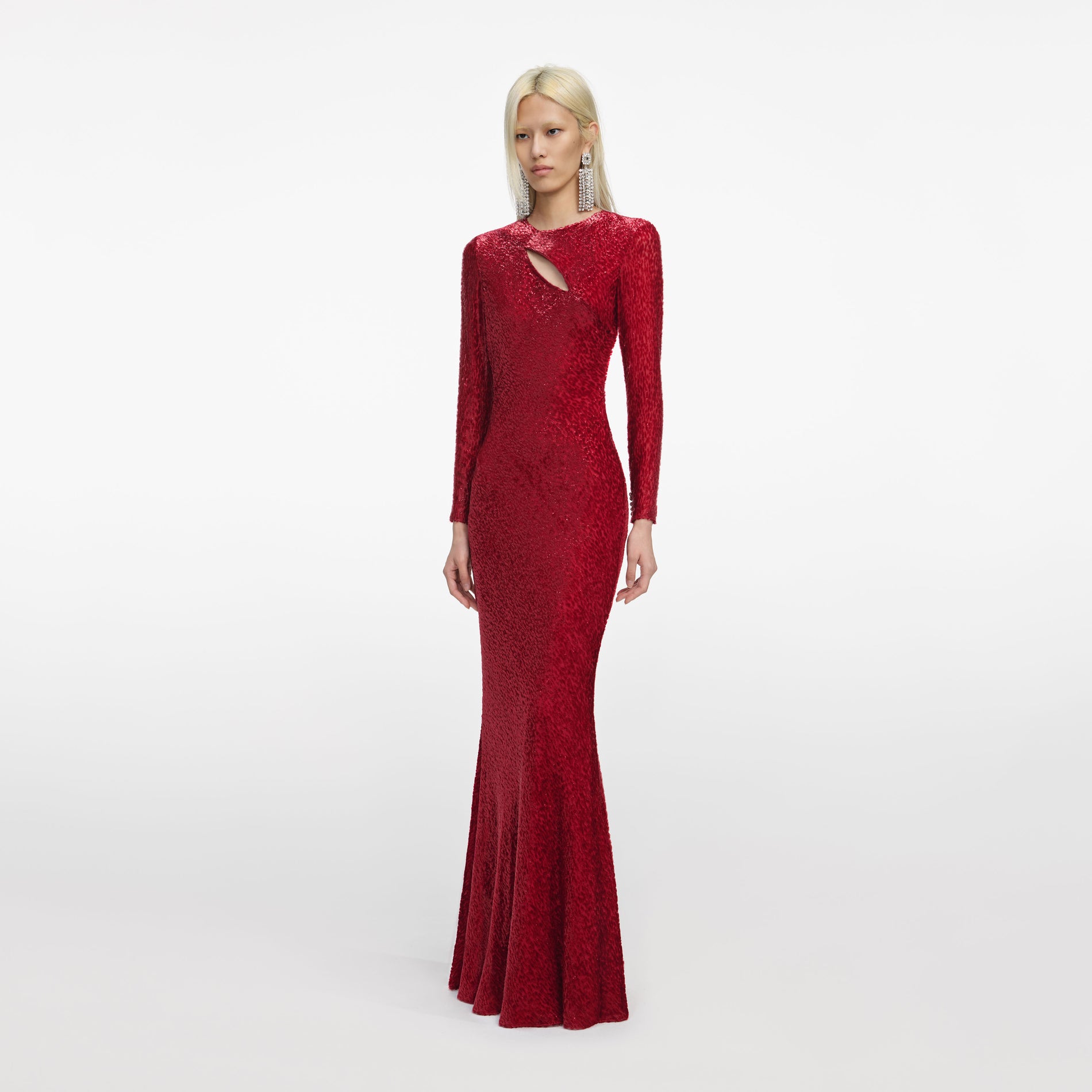 Side view of a woman wearing the Red Fil Coupe Maxi Dress