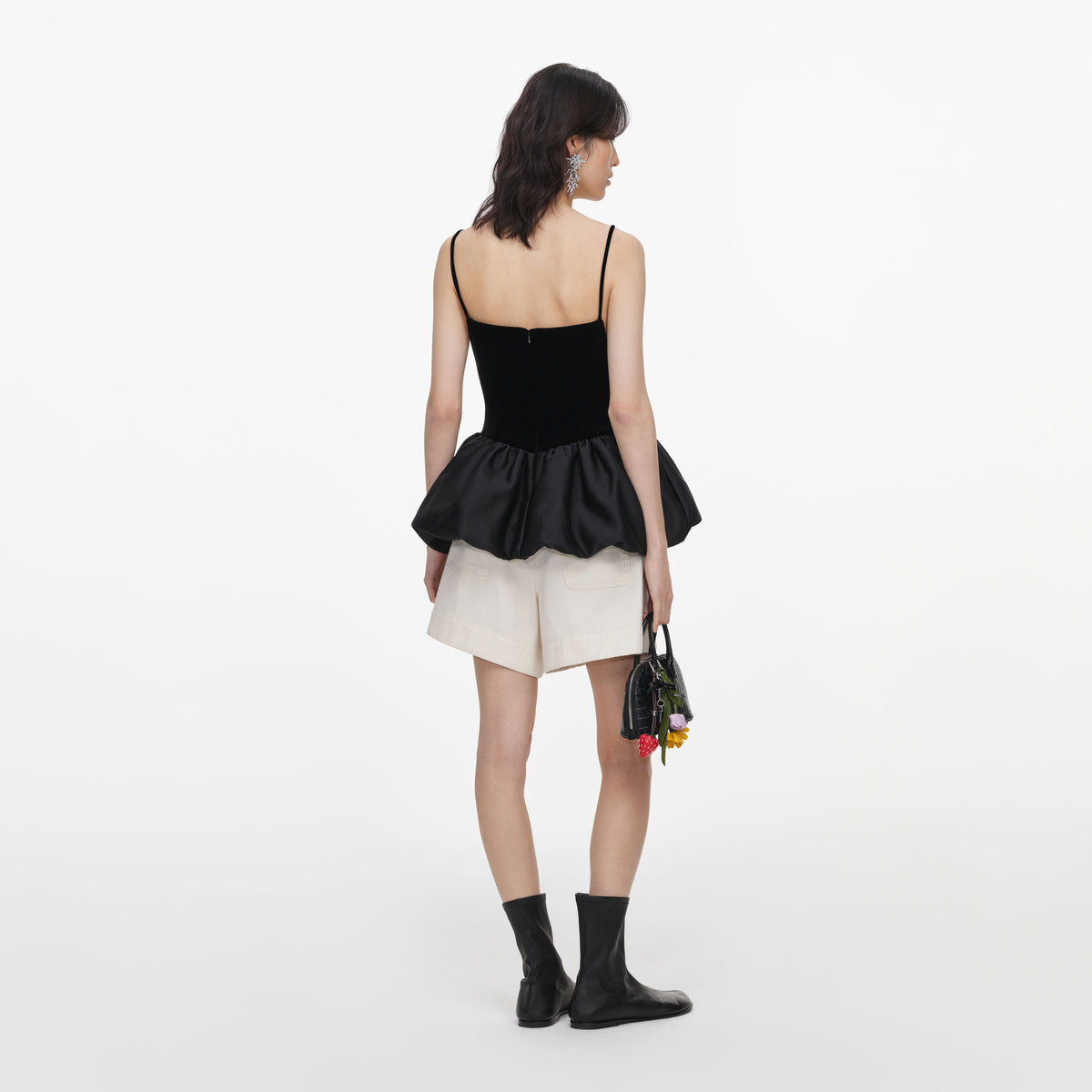 Back view of a woman wearing the Black Velvet Bubble Hem Top