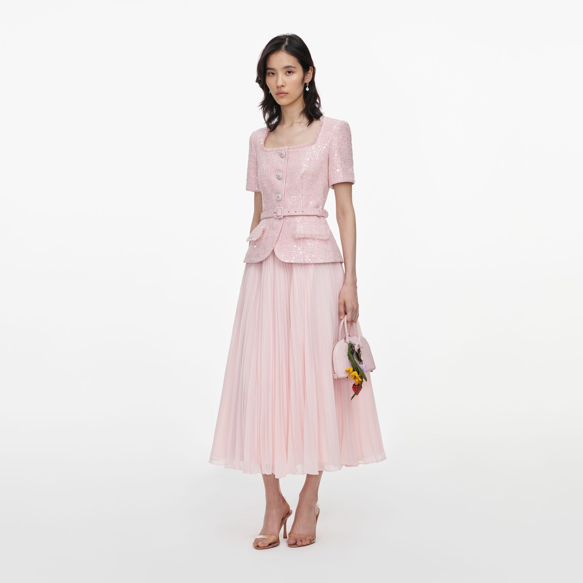 Side view of a woman wearing the Pink Sequin Boucle Midi Dress