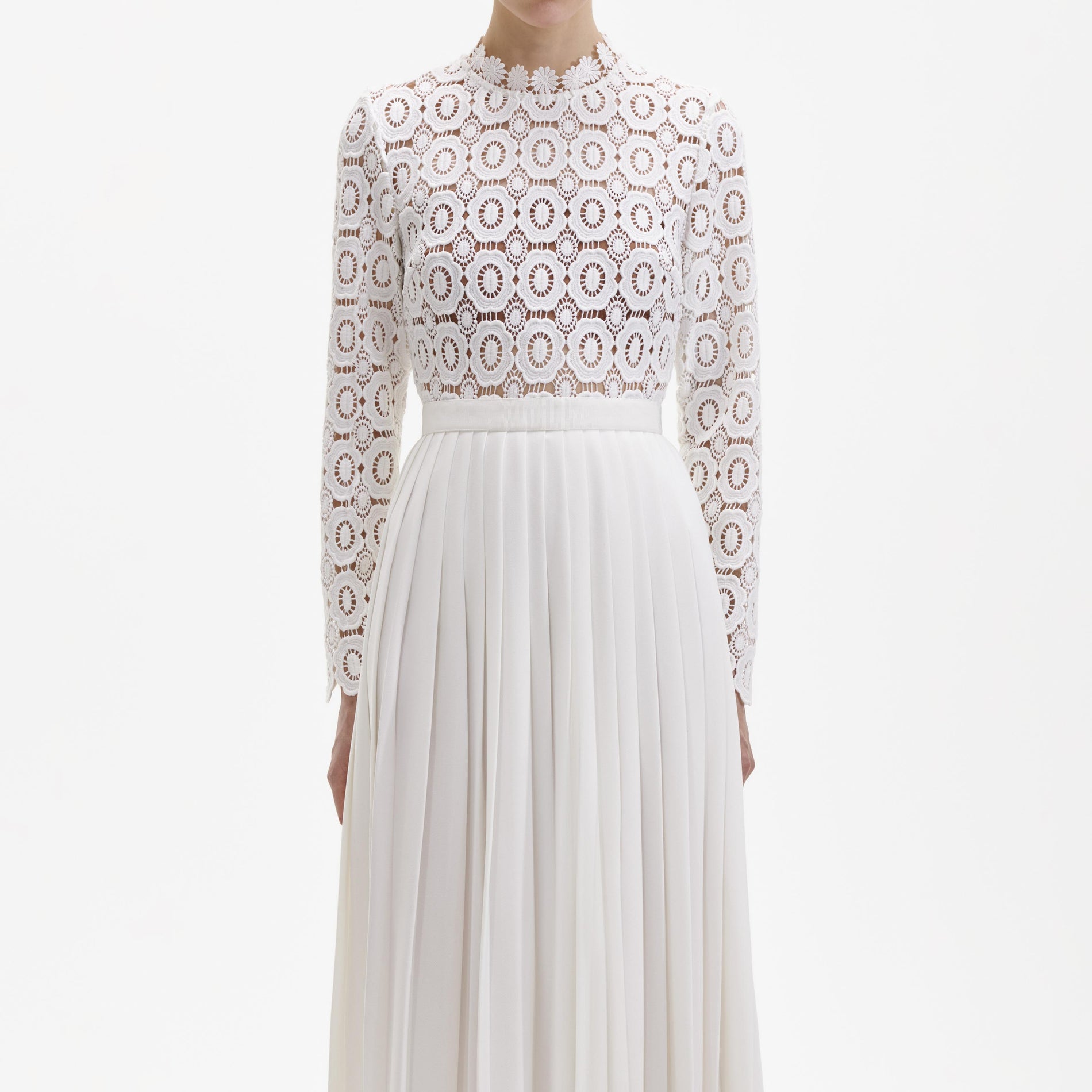 A close up of a woman wearing the Pleated Crochet Floral Maxi Dress