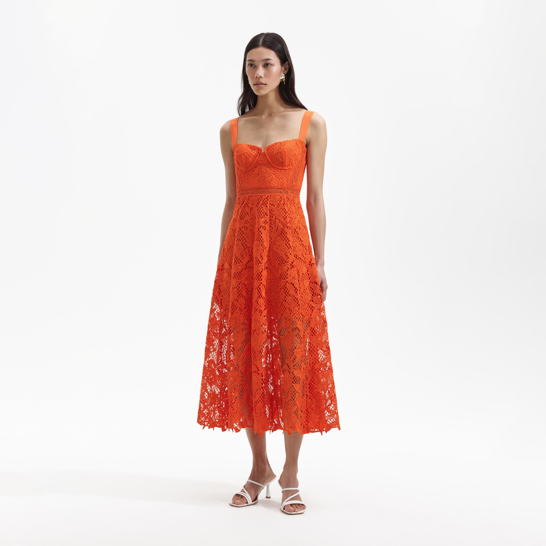 Side view of a woman wearing the Orange Lace Midi Dress