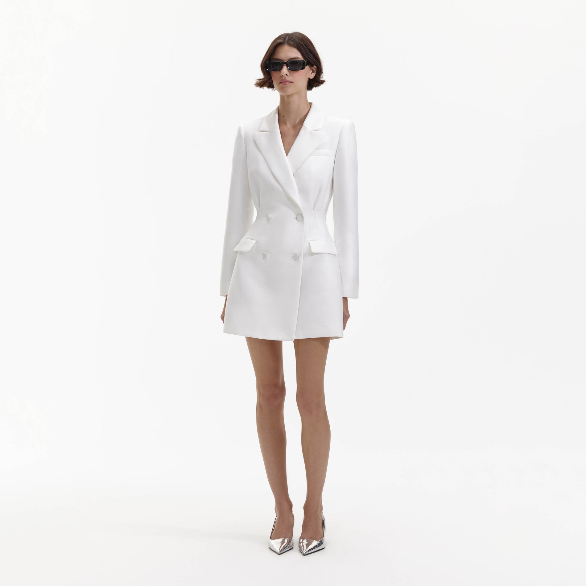 Side view of a woman wearing the White Taffeta Tailored Mini Dress