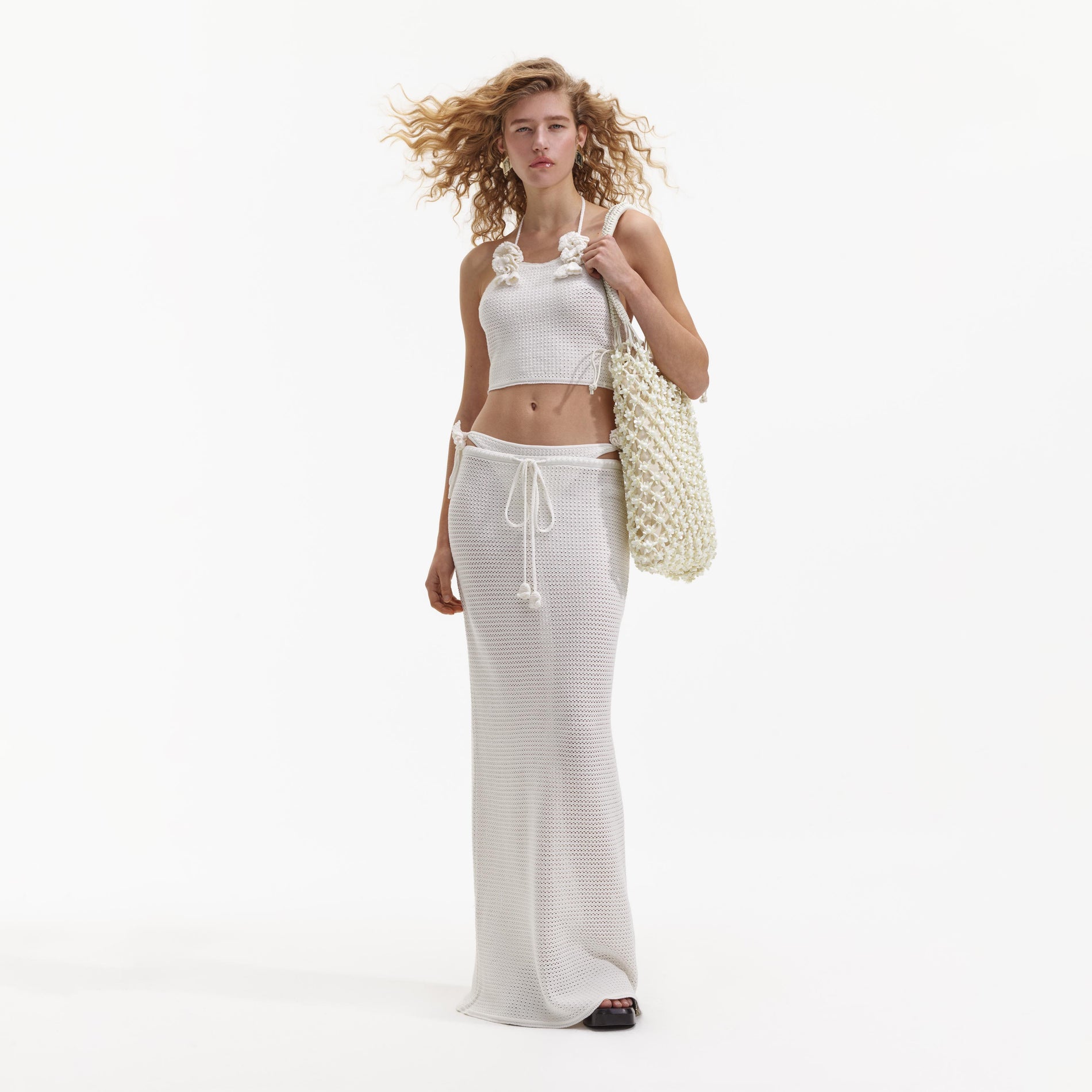 A Woman wearing the White Crochet Maxi Skirt