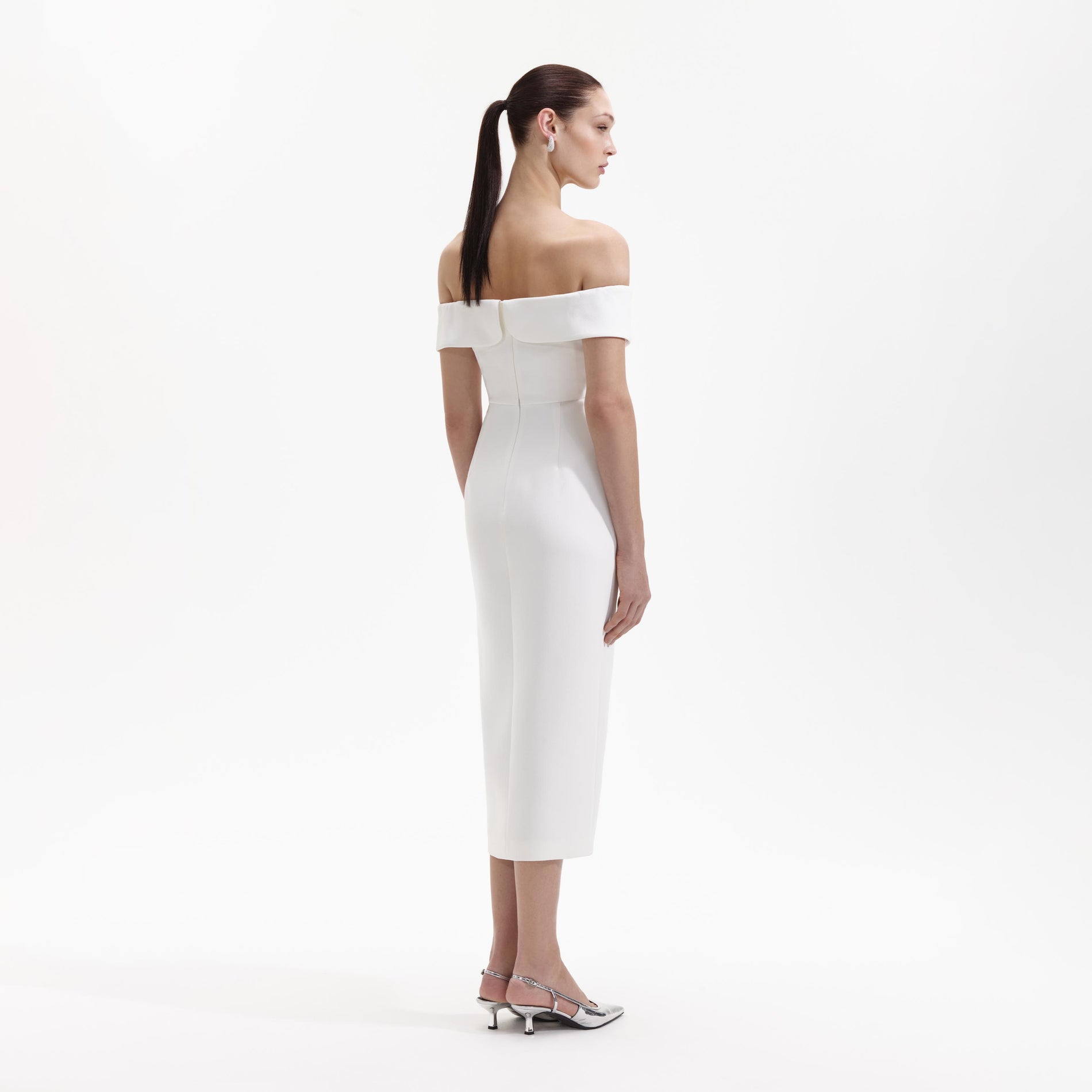 A Woman wearing the White Crepe Bow Off Shoulder Midi Dress
