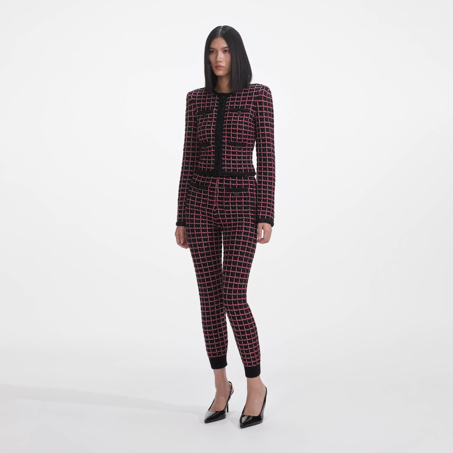 Side view of a woman wearing the Black And Red Check Cardigan
