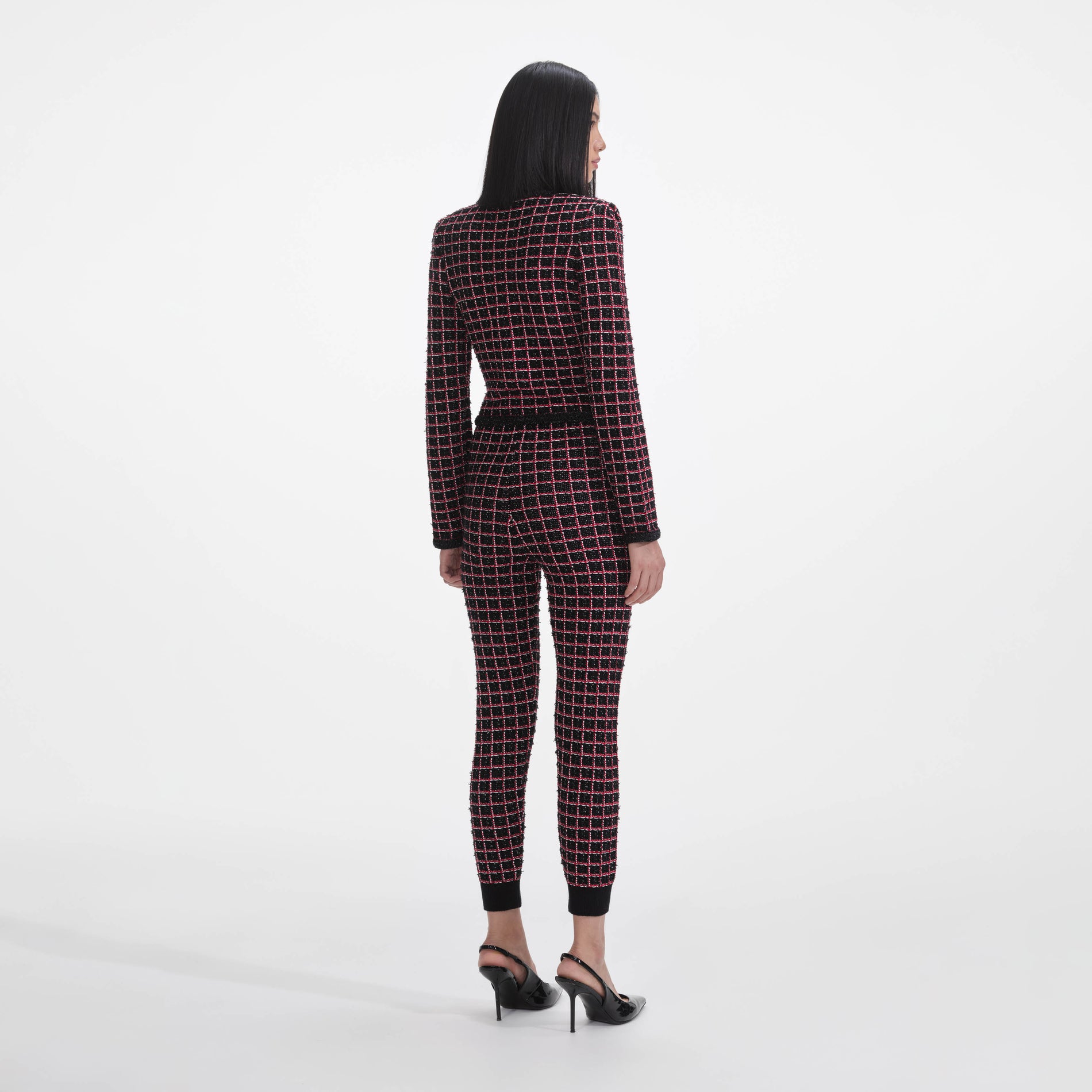 Back view of a woman wearing the Black And Red Check Cardigan