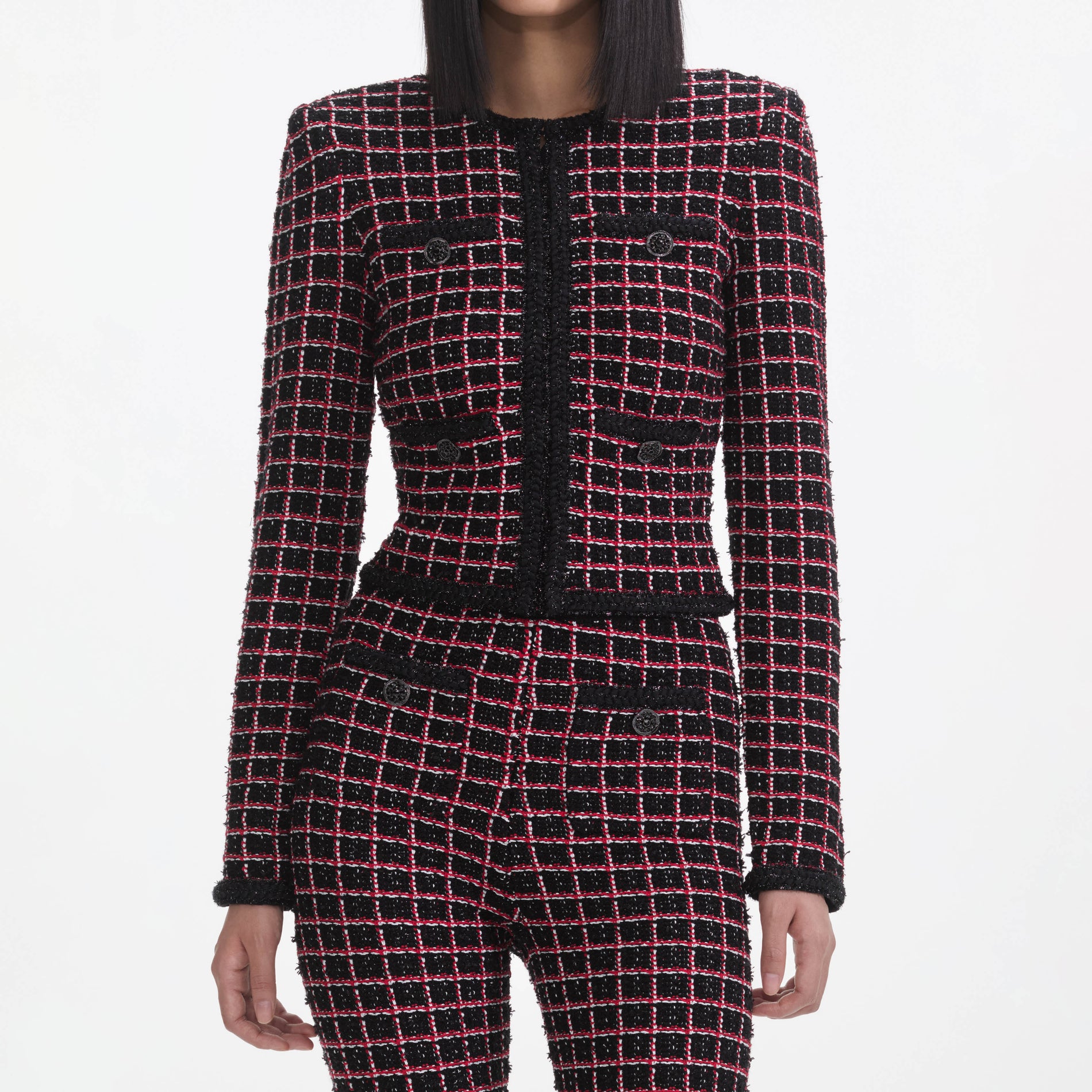 A close up of a woman wearing the Black And Red Check Knit Leggings