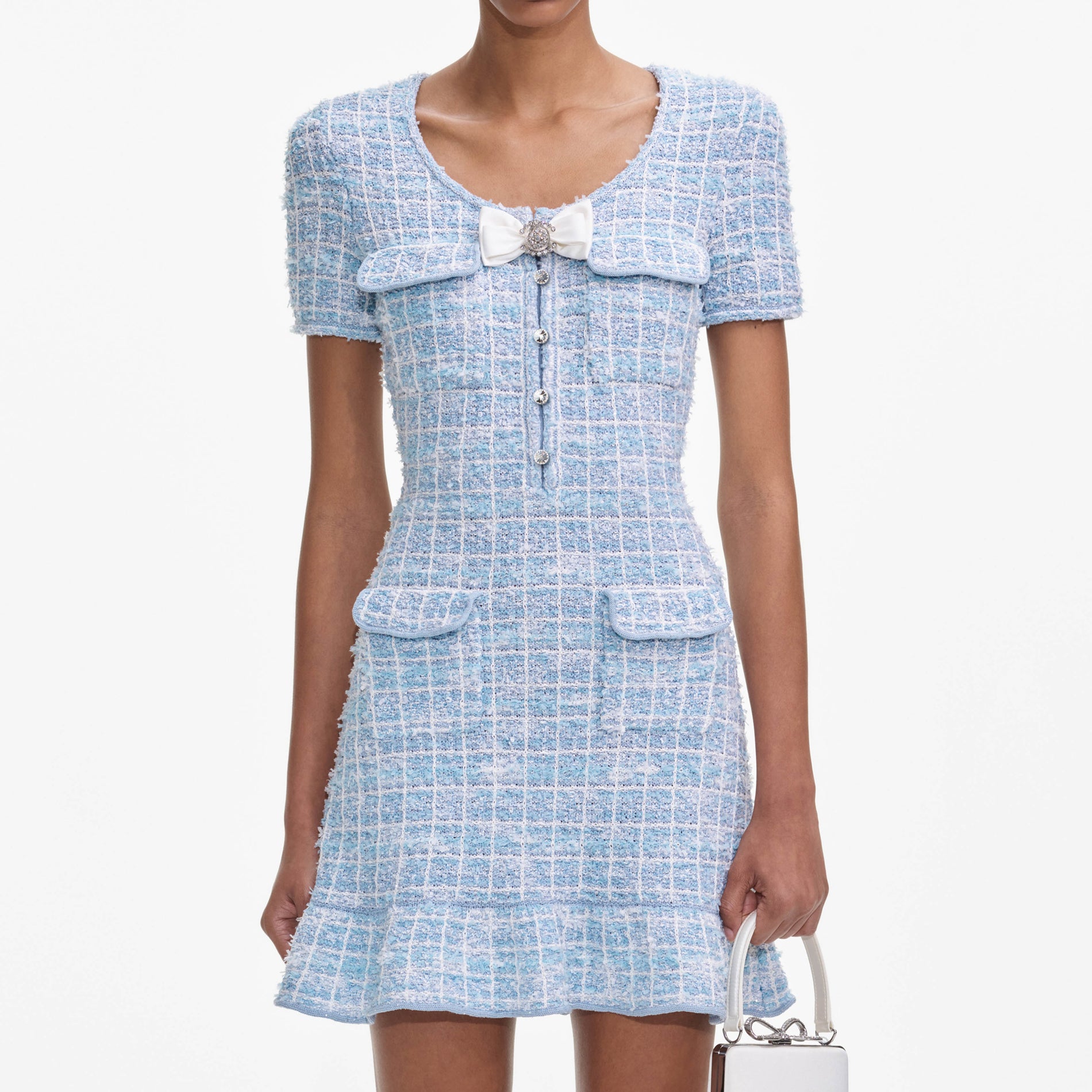 A close up of a woman wearing the Blue Check Knit Mini Dress
