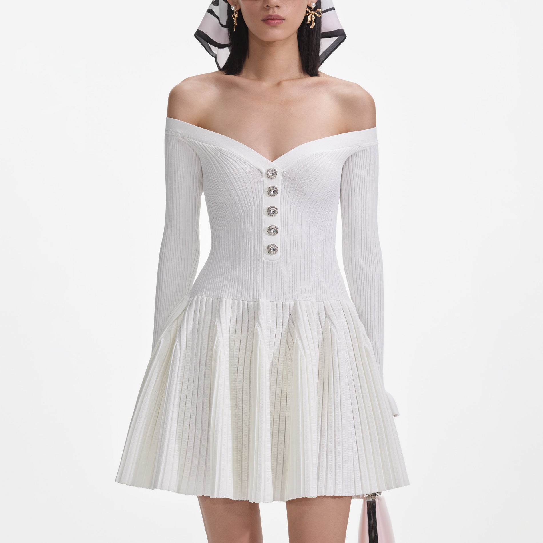 A close up of a woman wearing the White Ribbed Knit Mini Dress