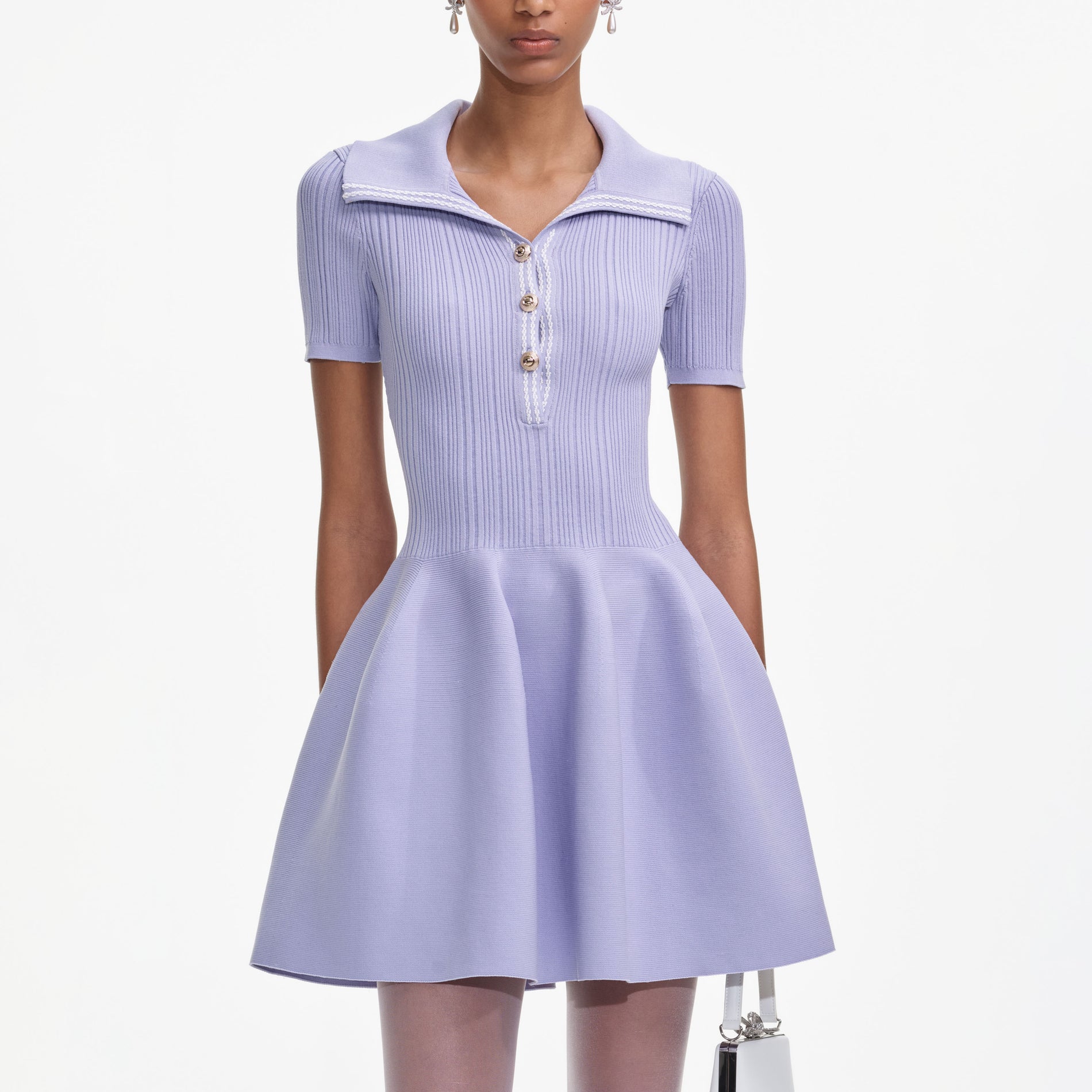 A close up of a woman wearing the Lilac Ribbed Knit Mini Dress