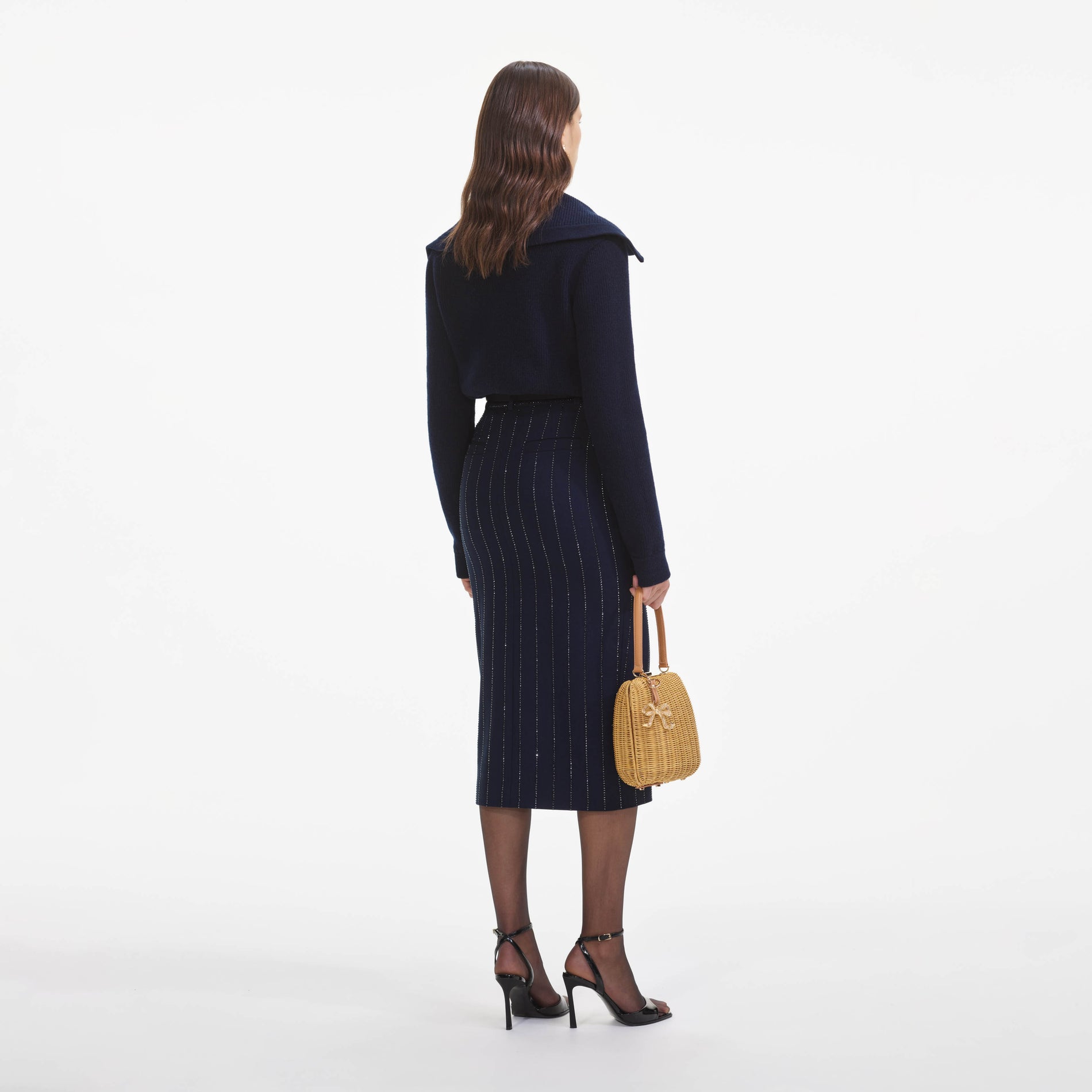 Back view of a woman wearing the Navy Relaxed Fit Cardigan