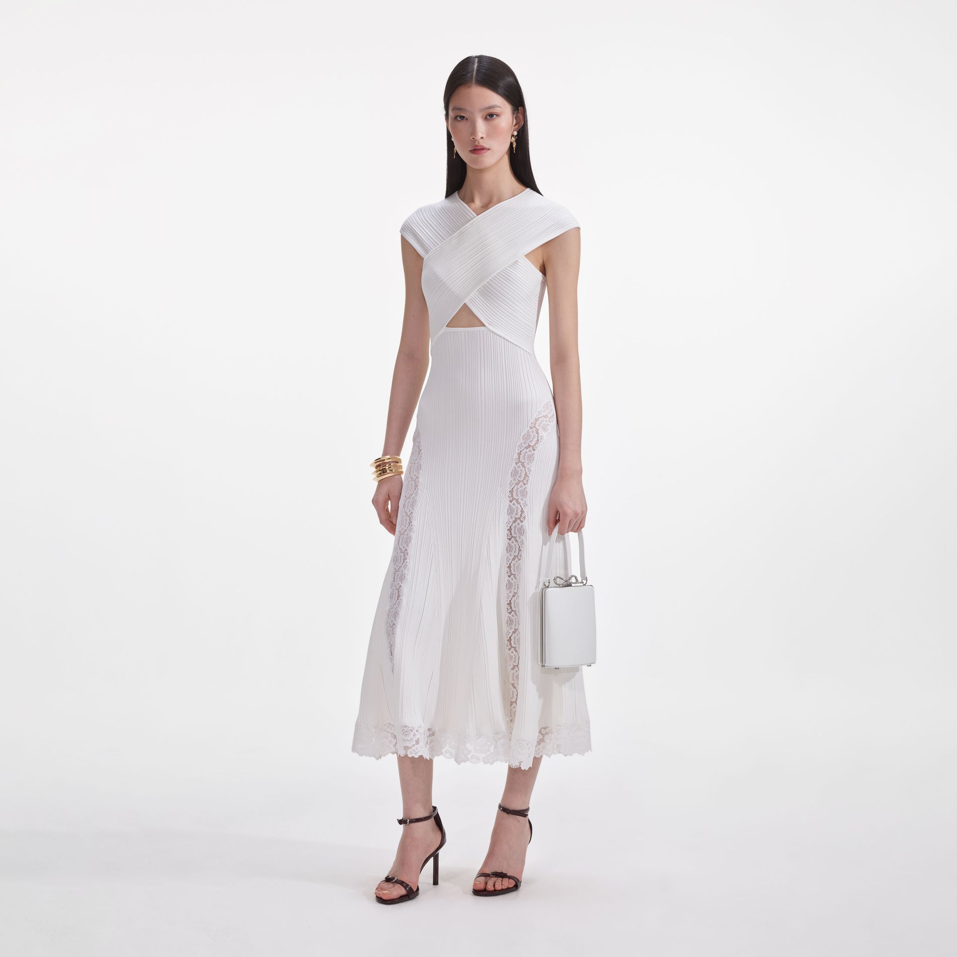 Side view of a woman wearing the White Knit Lace Insert Midi Dress
