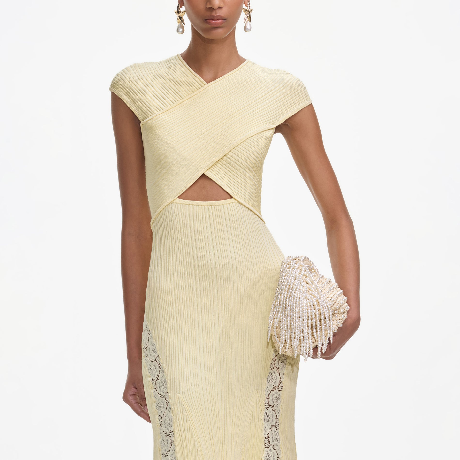 A close up of a woman wearing the Yellow Knit Lace Insert Midi Dress