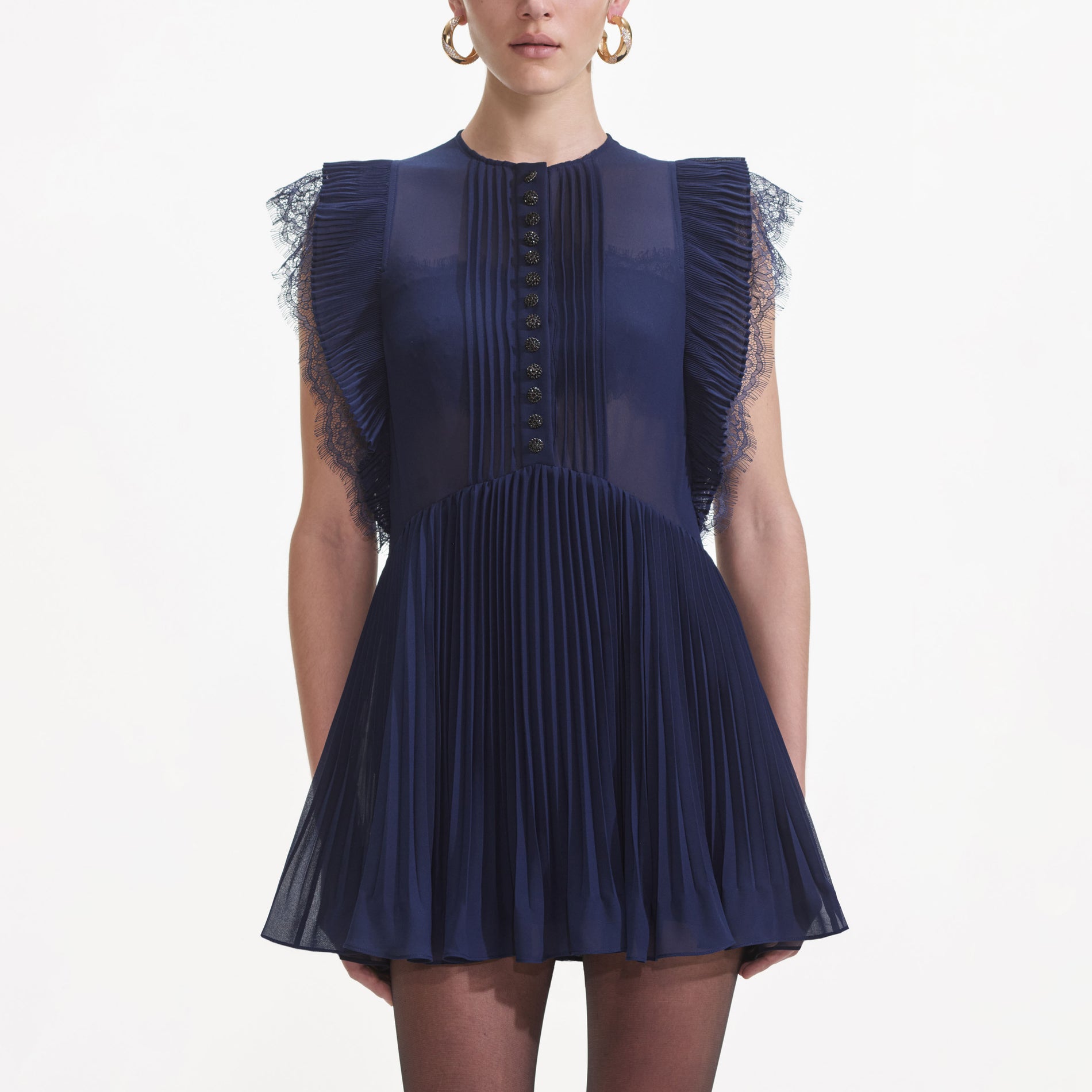 A close up of a woman wearing the Navy Chiffon Ruffle Mini Dress