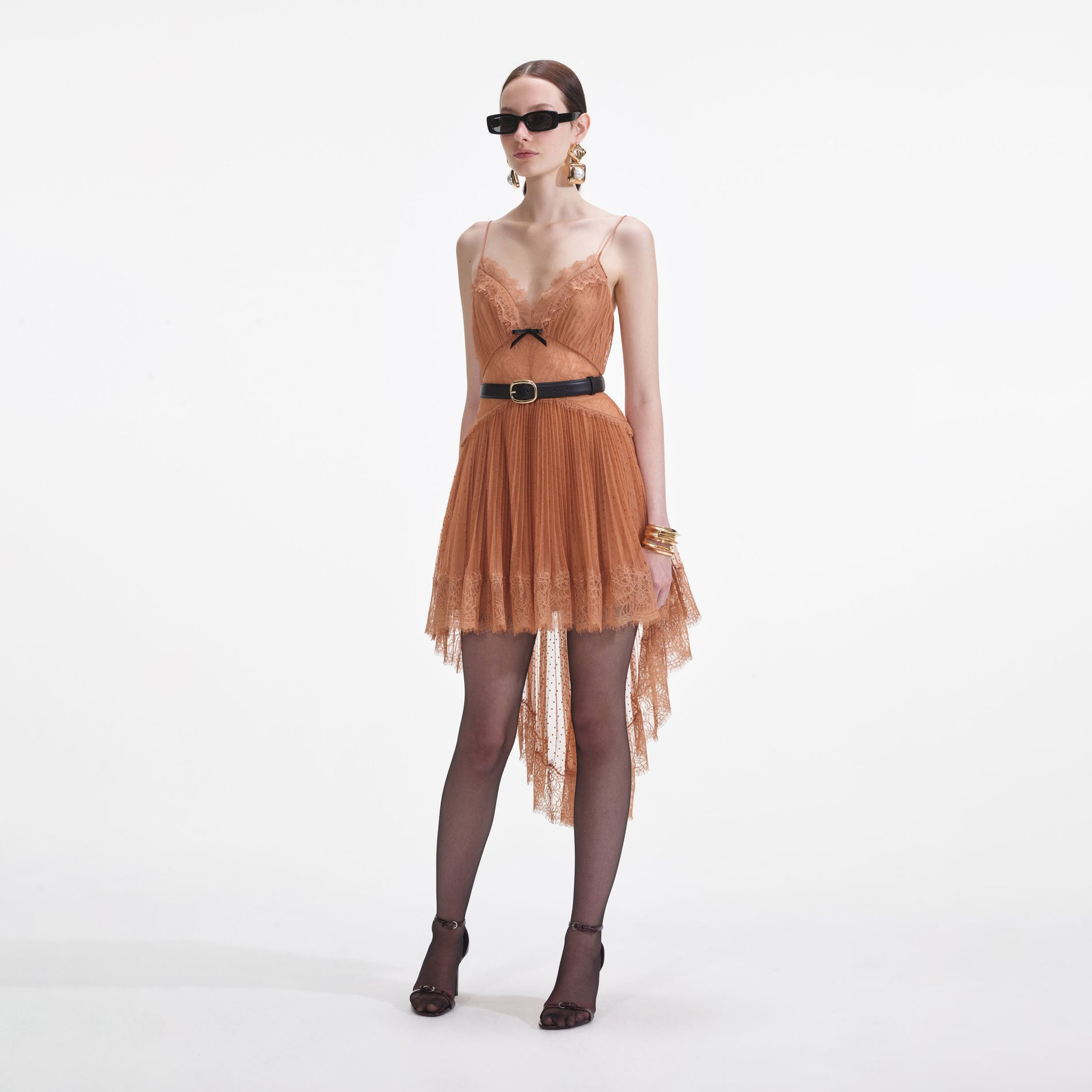 Side view of a woman wearing the Tan Dot Mesh Mini Dress