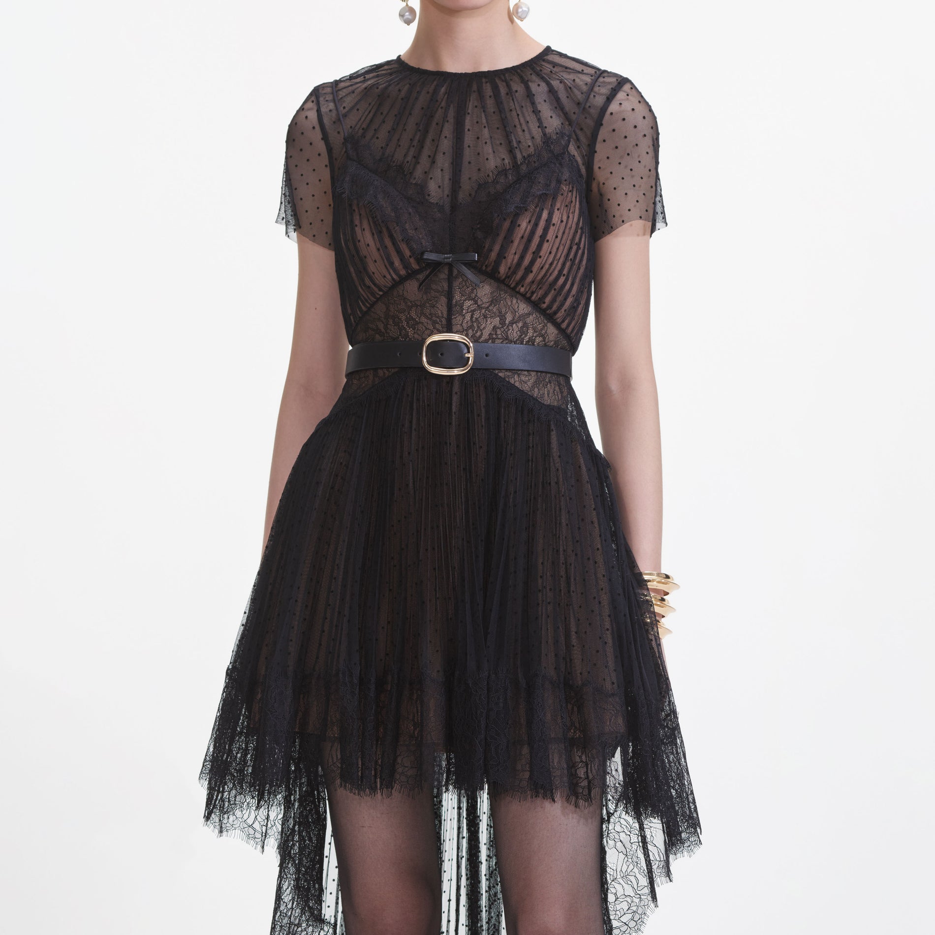 A close up of a woman wearing the Black Dot Mesh Mini Dress