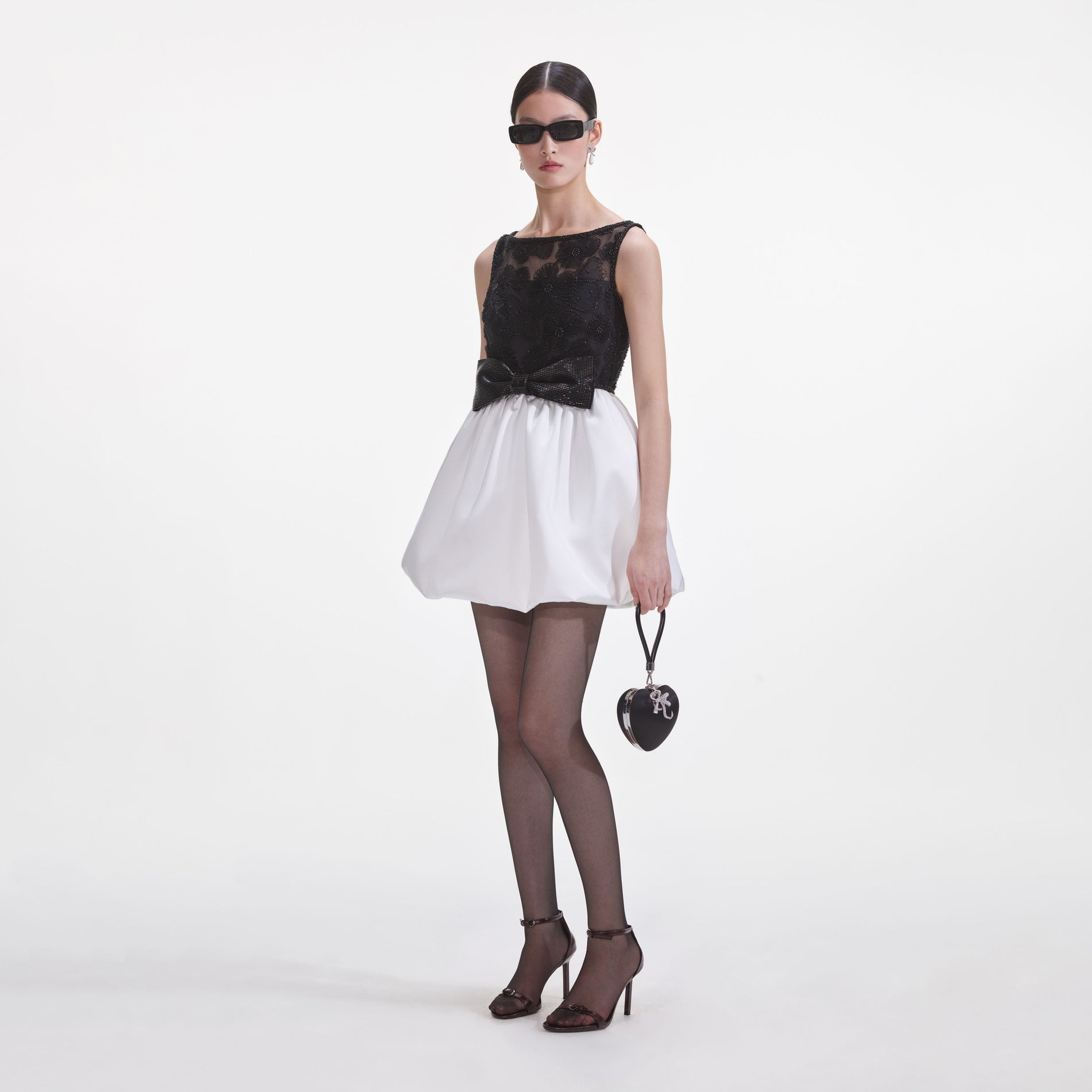 Side view of a woman wearing the Black And White Tulle Mini Dress