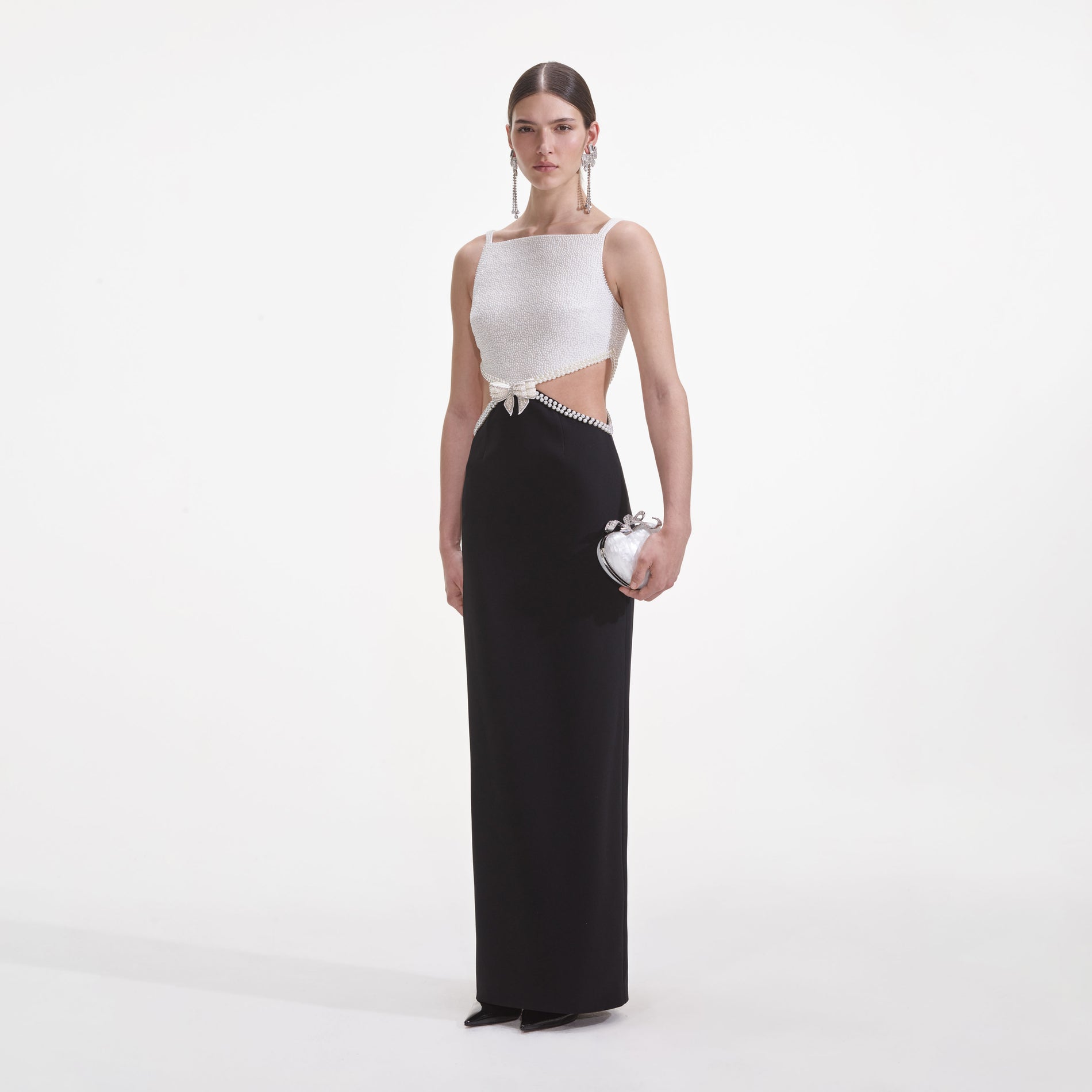 Side view of a woman wearing the Black And White Crepe Maxi Dress