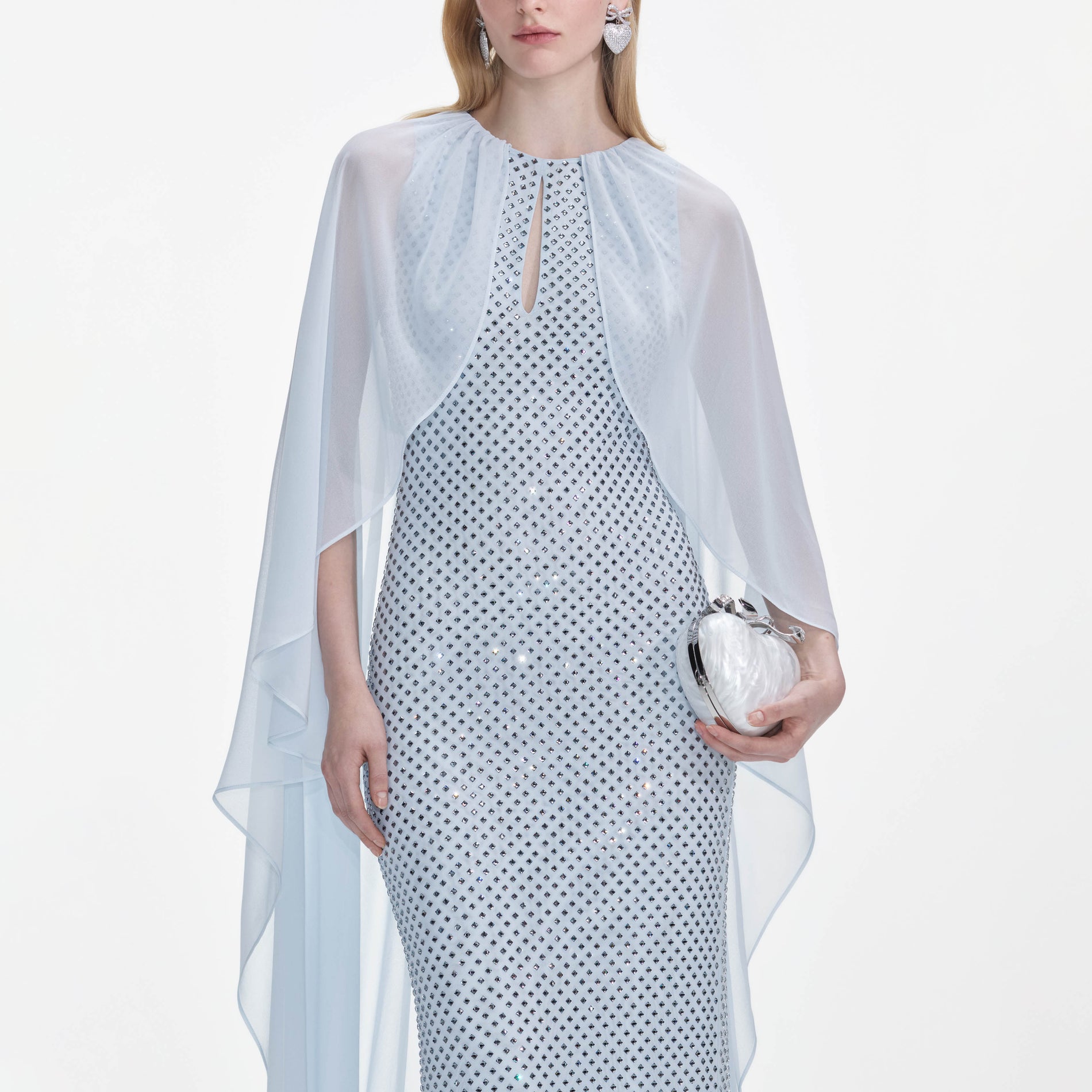 A close up of a woman wearing the Pale Blue Rhinestone Cape Maxi Dress