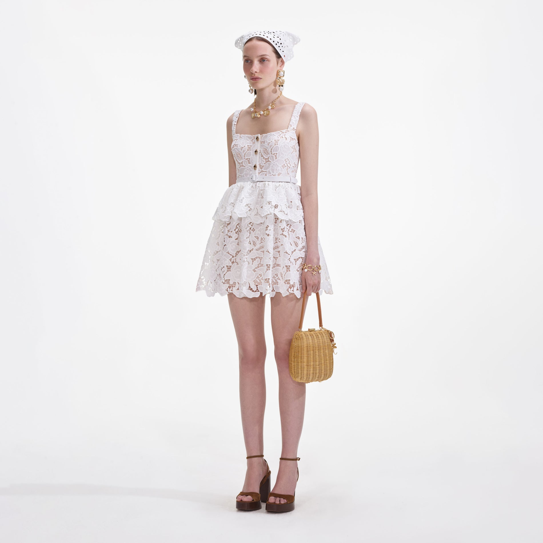 Side view of a woman wearing the White Lace Tiered Mini Dress