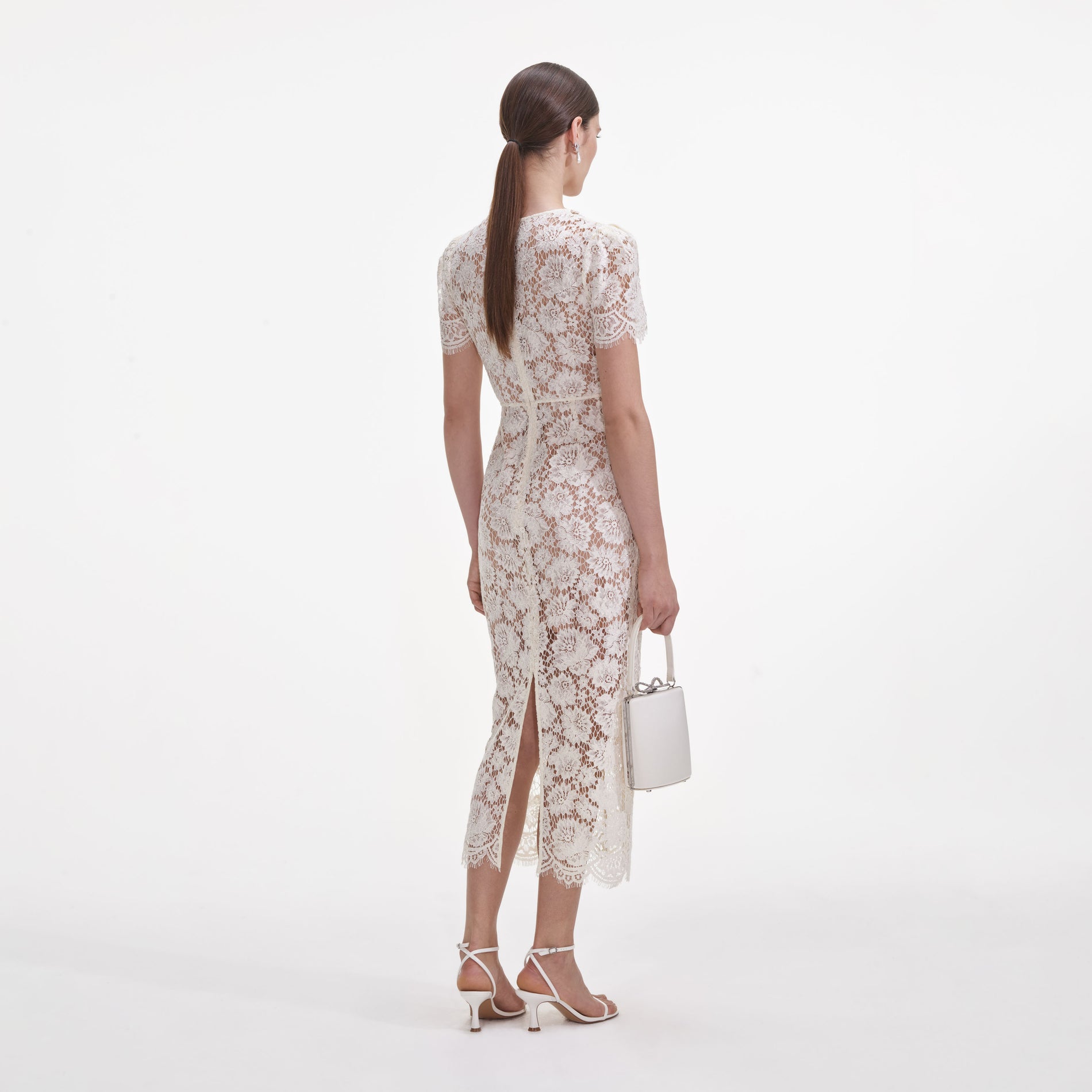 Back view of a woman wearing the Cream Fine Lace Pearl Midi Dress