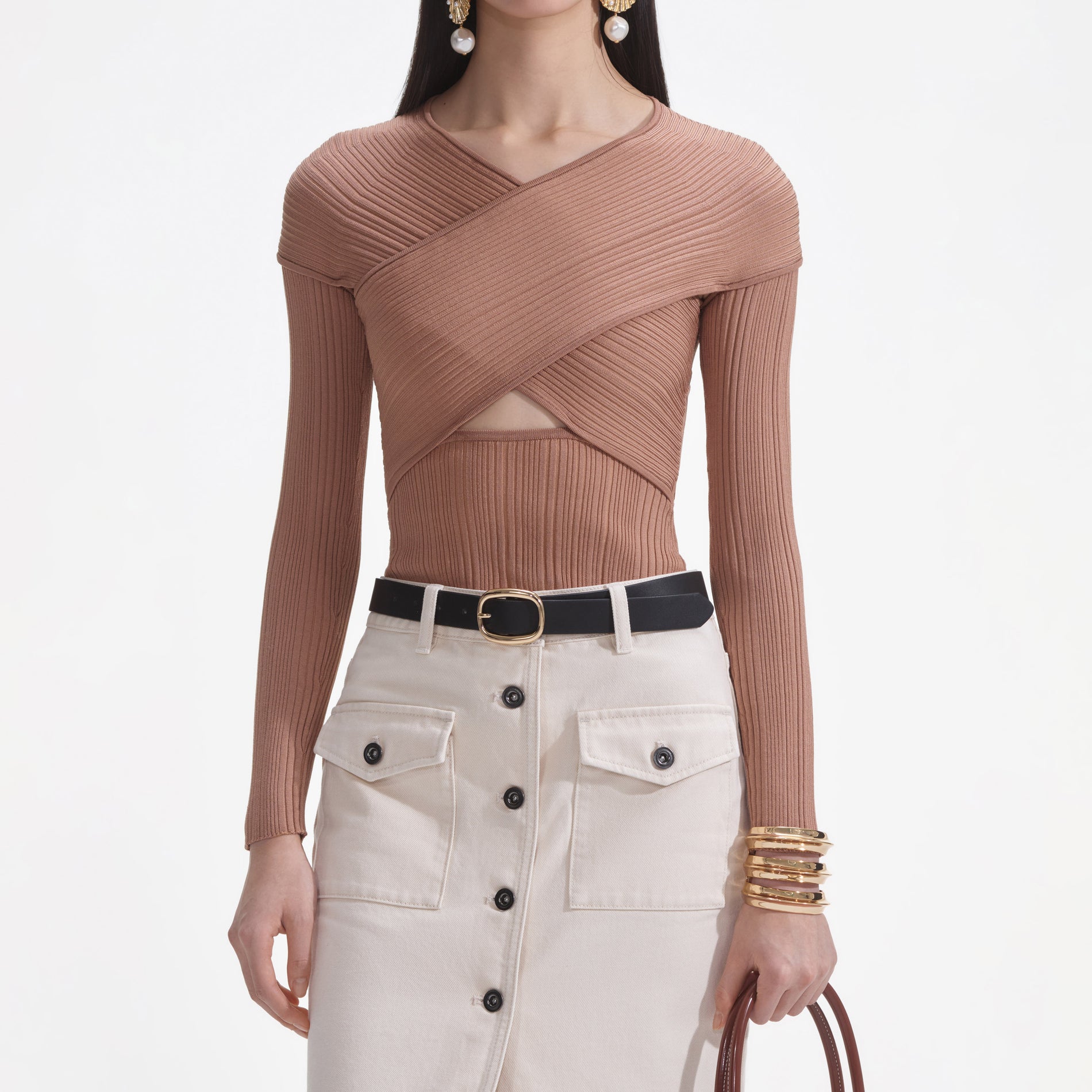 A close up of a woman wearing the Beige Ribbed Knit Wrap Top