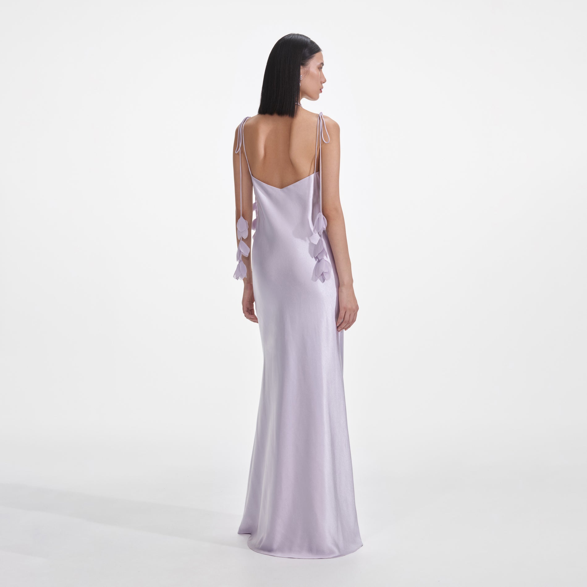 Back view of a woman wearing the Lilac Flower Satin Maxi Dress