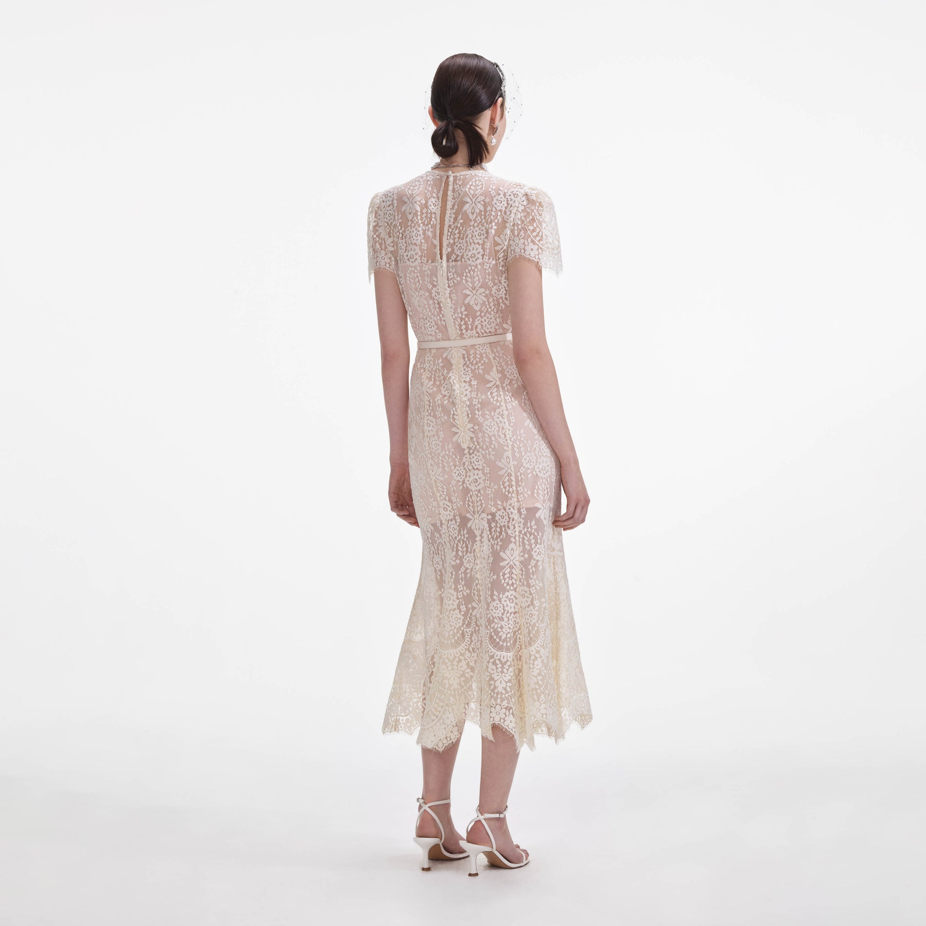 Back view of a woman wearing the White Lace Midi Dress