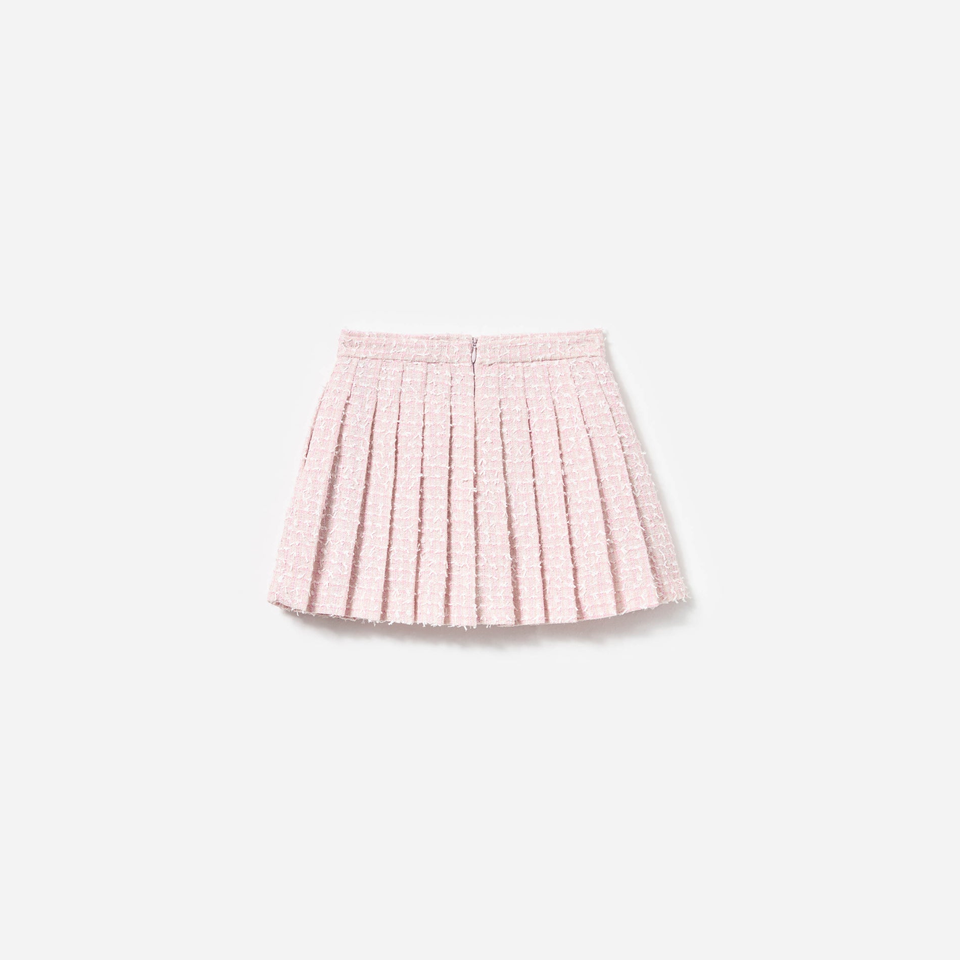 Side view of a woman wearing the Pink Bow Boucle Skirt