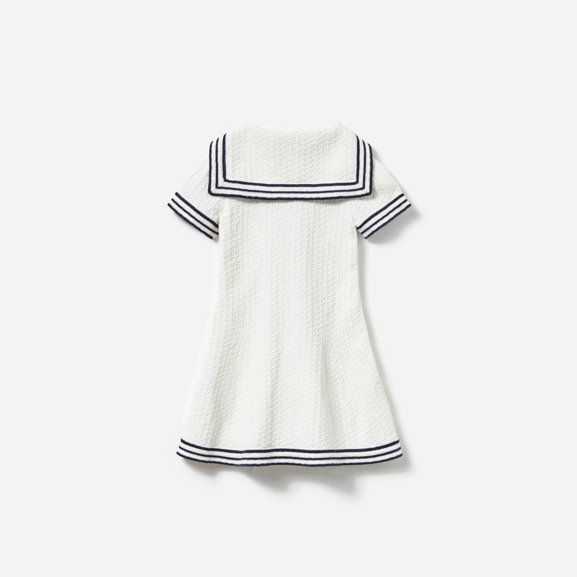 Side view of a woman wearing the Cream Textured Knit Dress