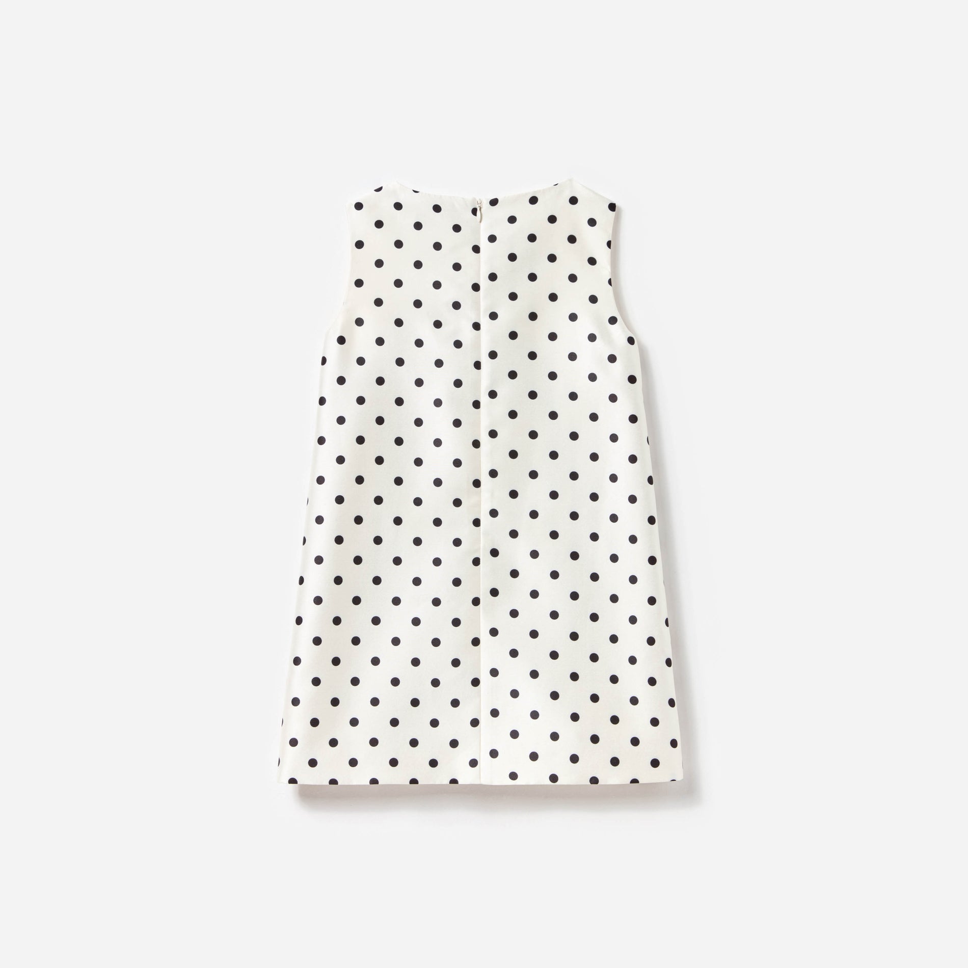 Side view of a woman wearing the Cream Sleeveless Polka Dot Taffeta Dress