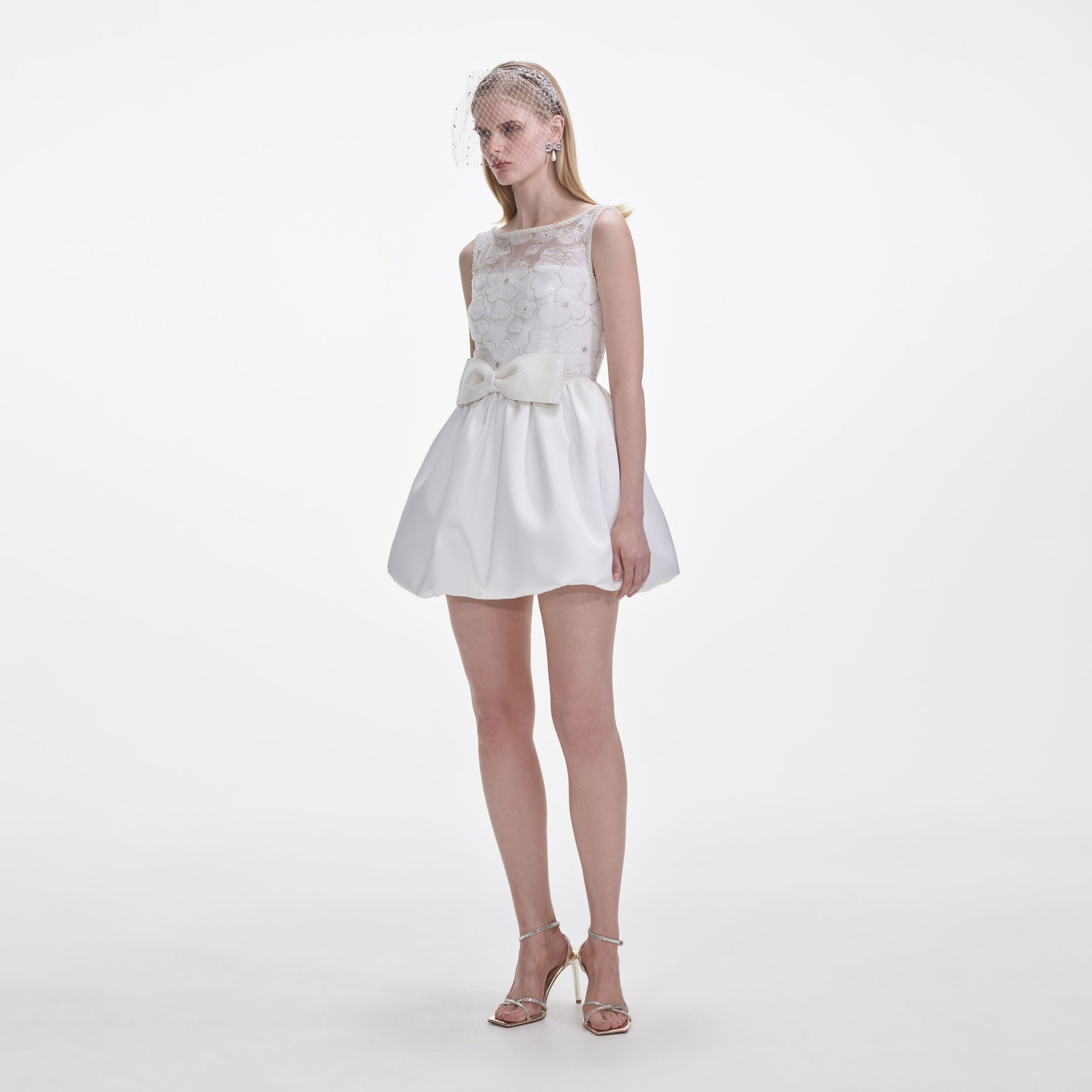 Side view of a woman wearing the White Tulle Mini Dress