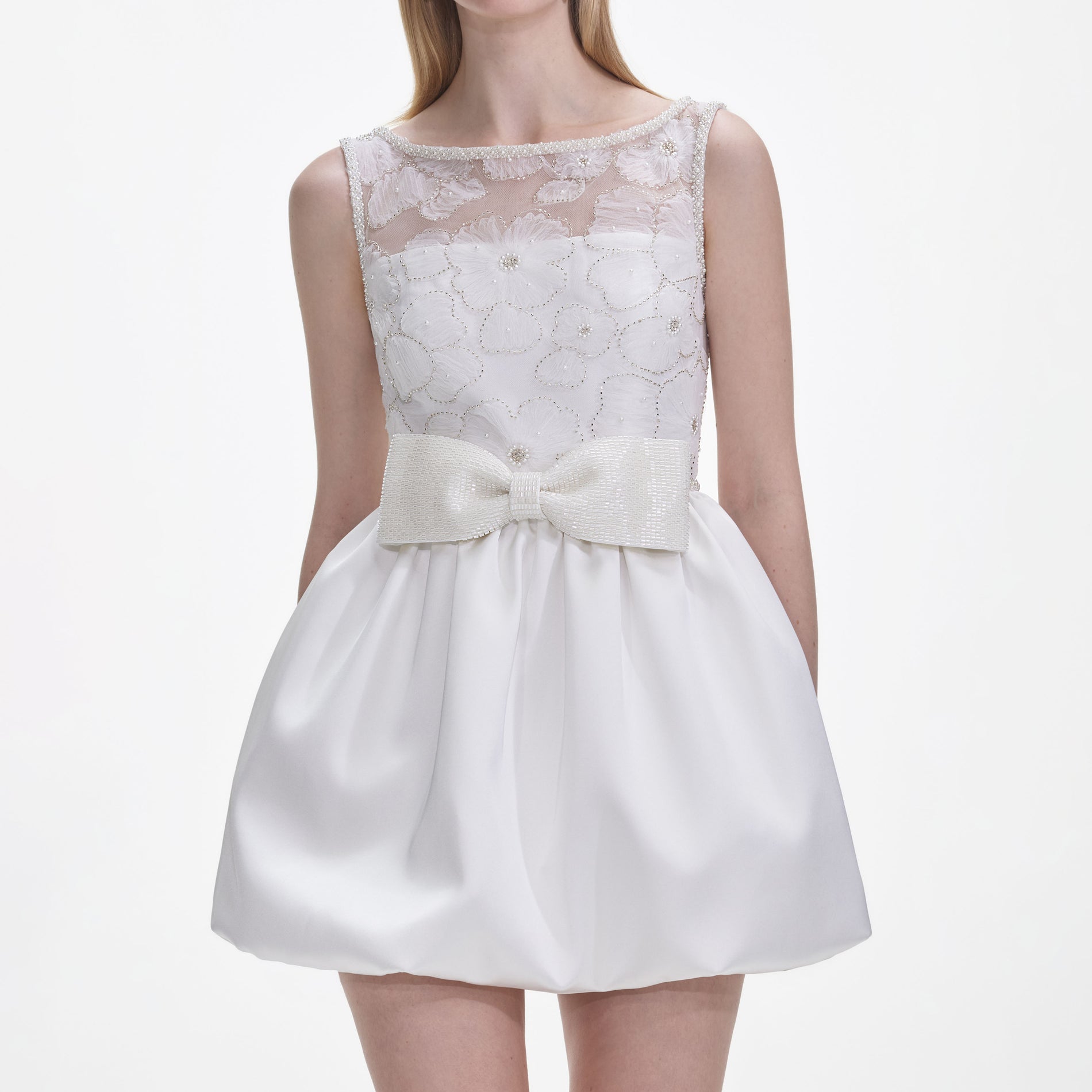 A close up of a woman wearing the White Tulle Mini Dress