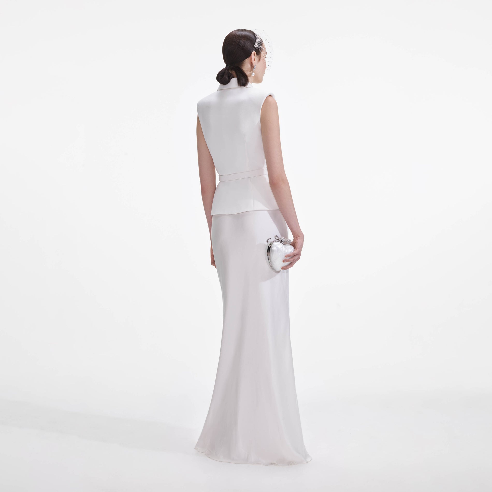 Back view of a woman wearing the White Crepe Maxi Dress