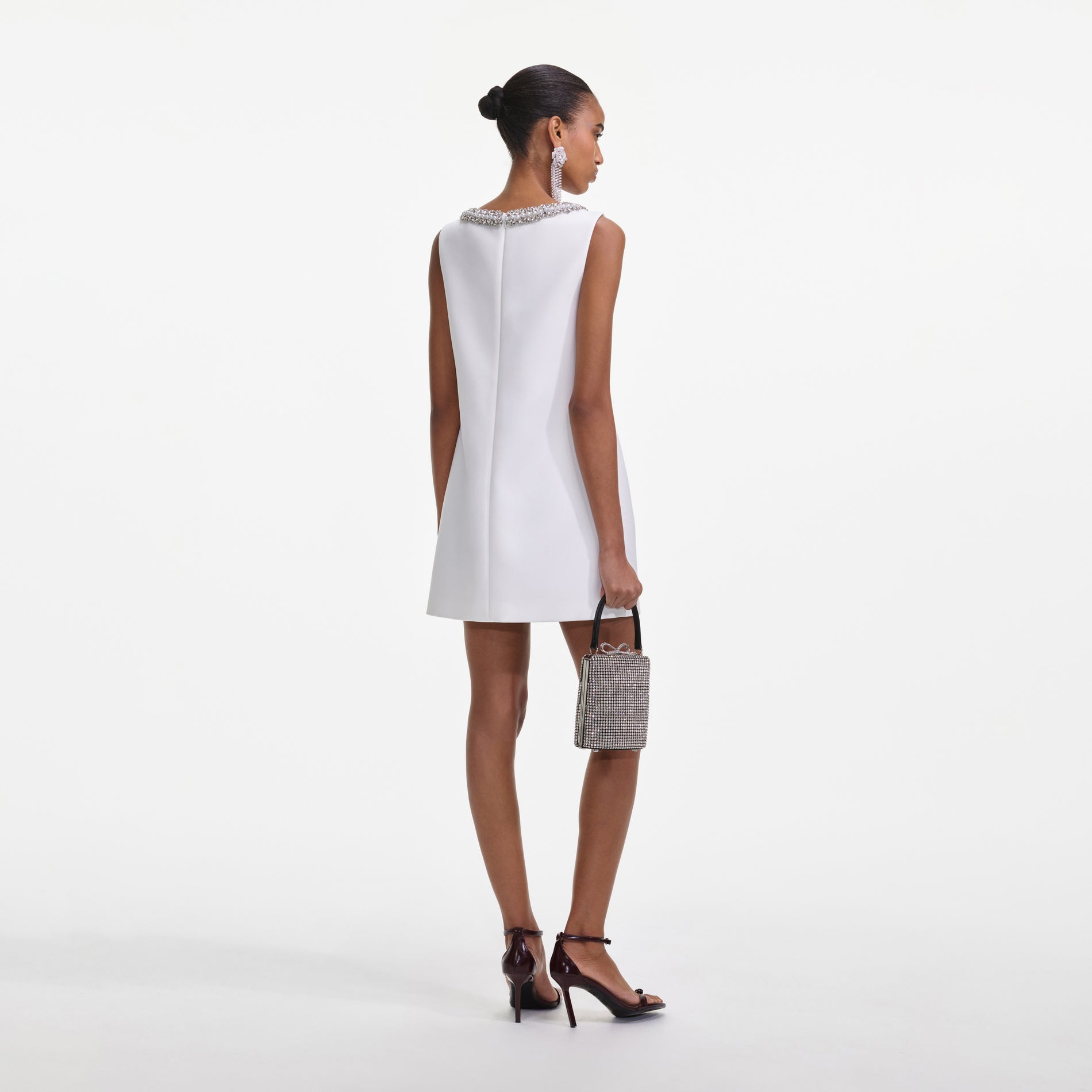 Back view of a woman wearing the White Bonded Crepe Mini Dress