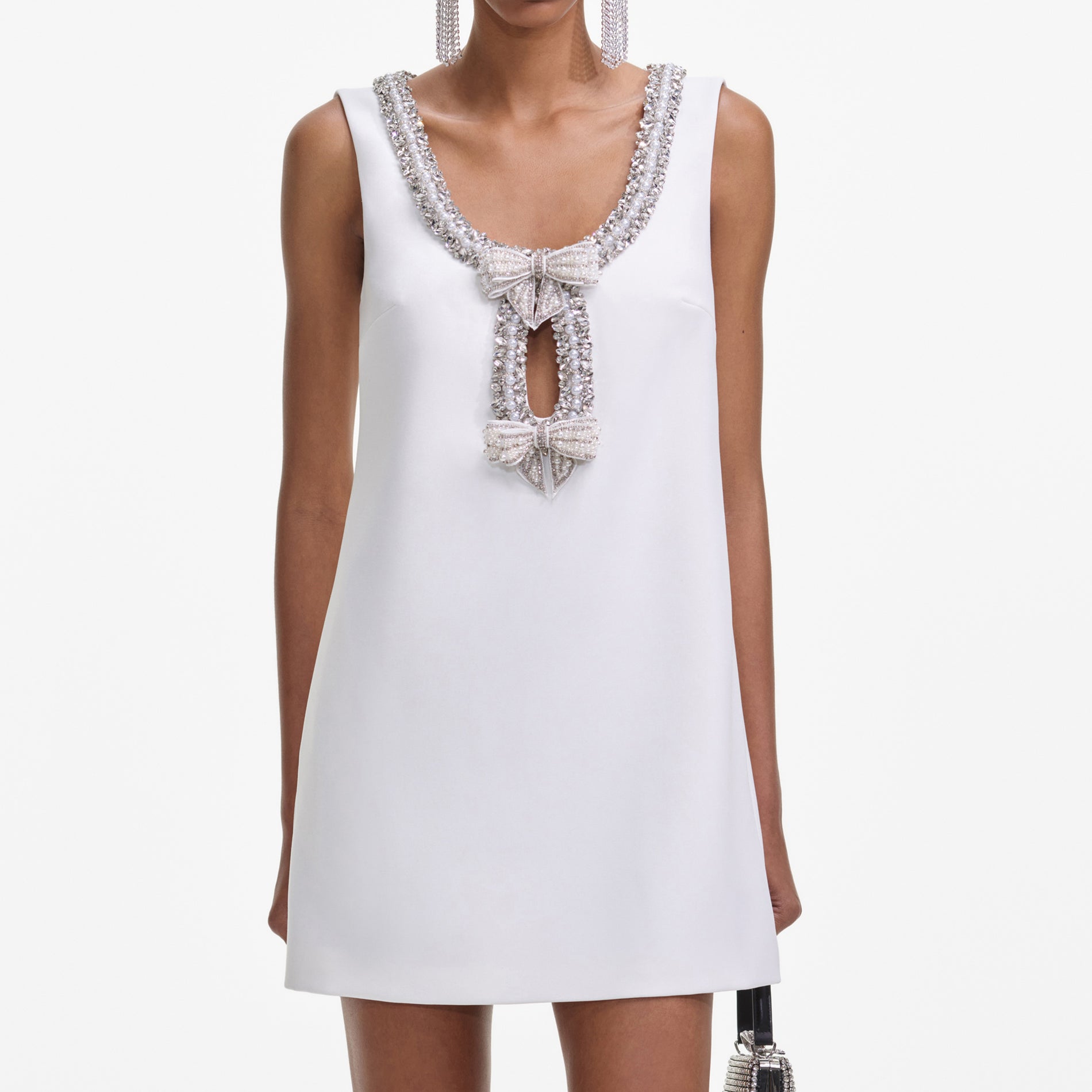 A close up of a woman wearing the White Bonded Crepe Mini Dress