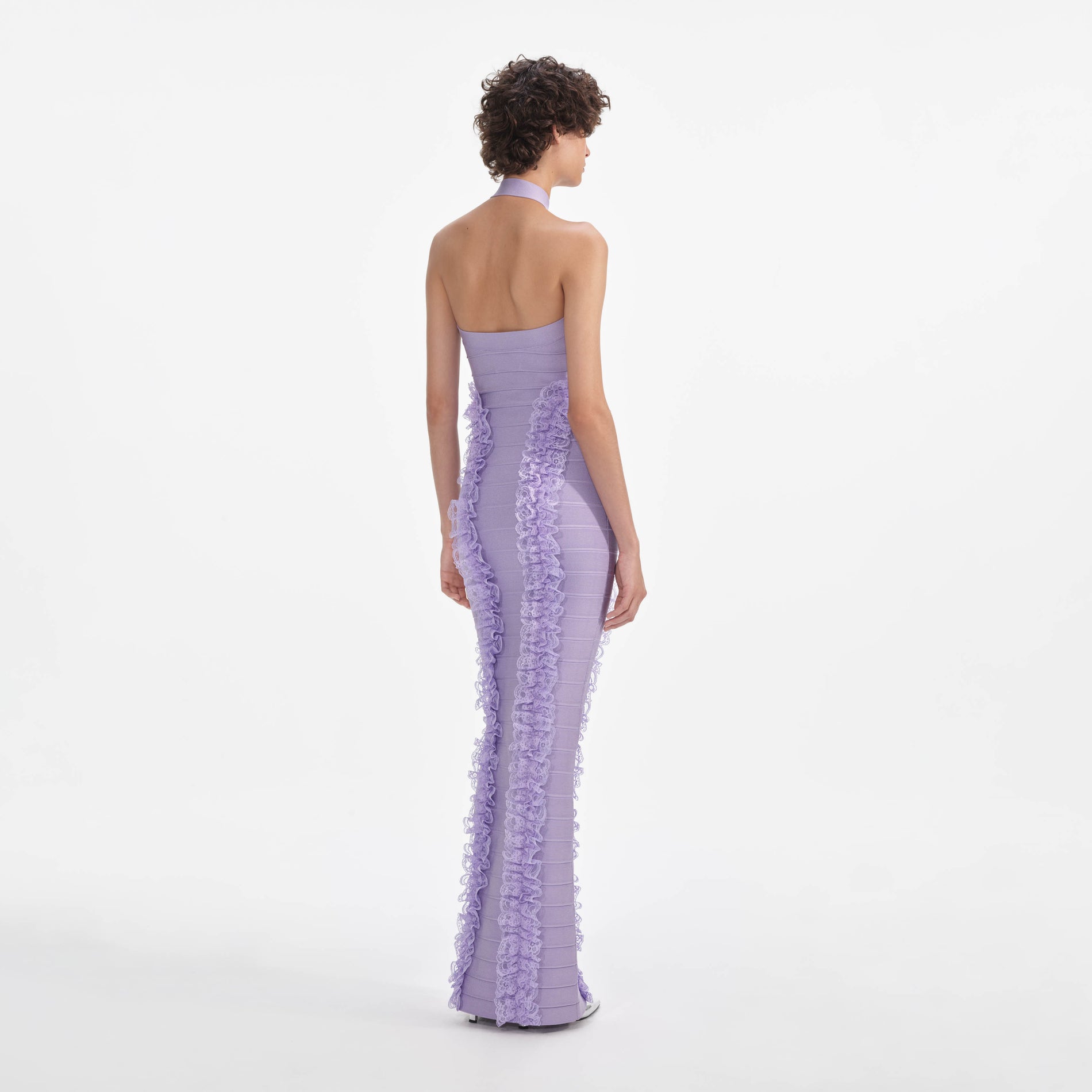 Back view of a woman wearing the Purple Knit Zip Ruffle Maxi Dress