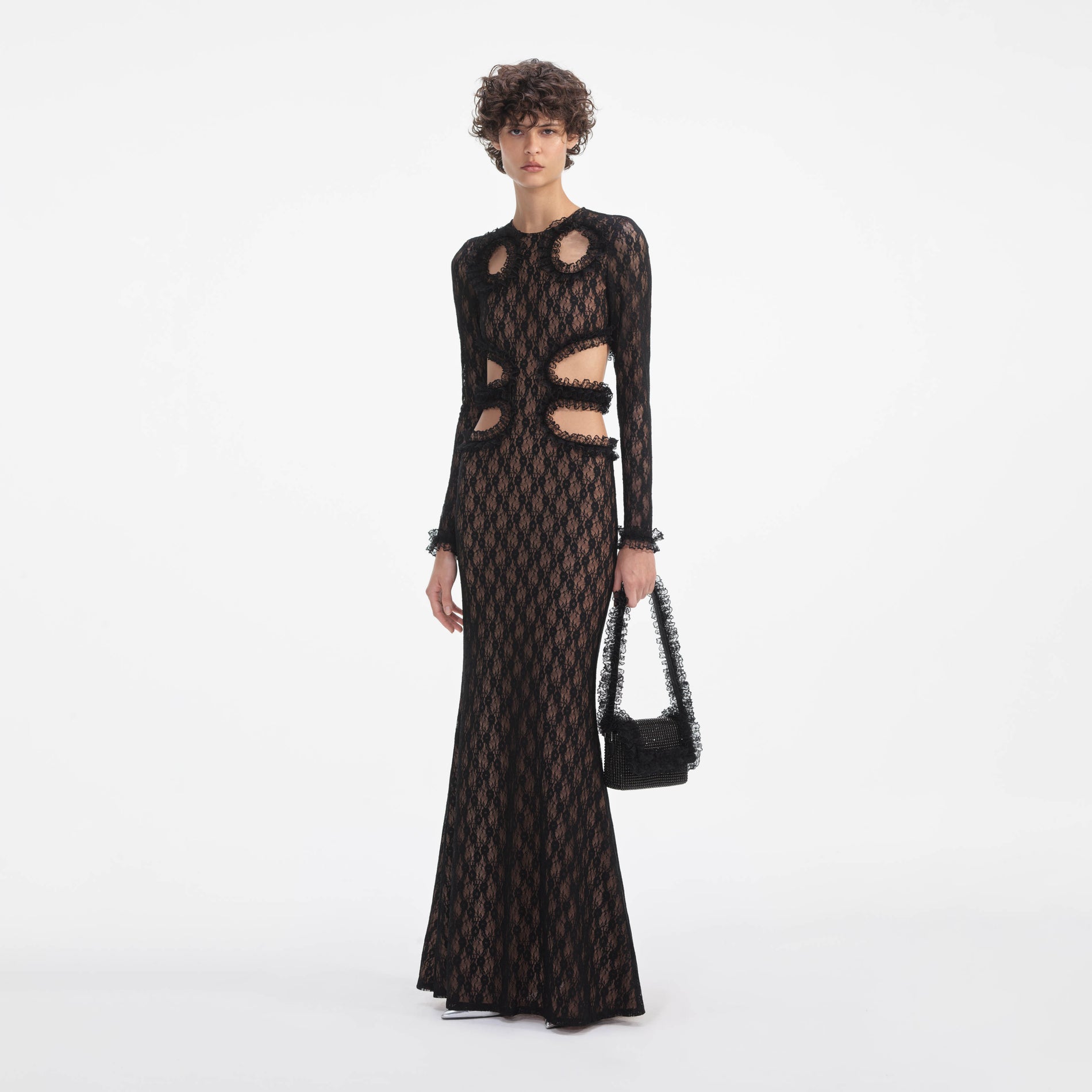 Side view of a woman wearing the Black Lace Cut Out Maxi Dress