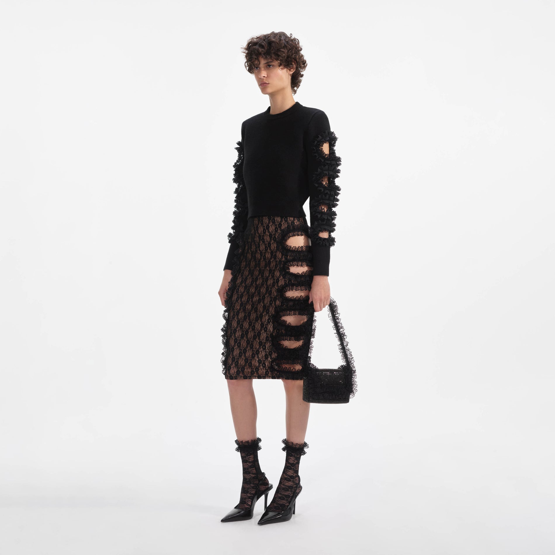 Side view of a woman wearing the Black Cut Out Lace Detail Jumper