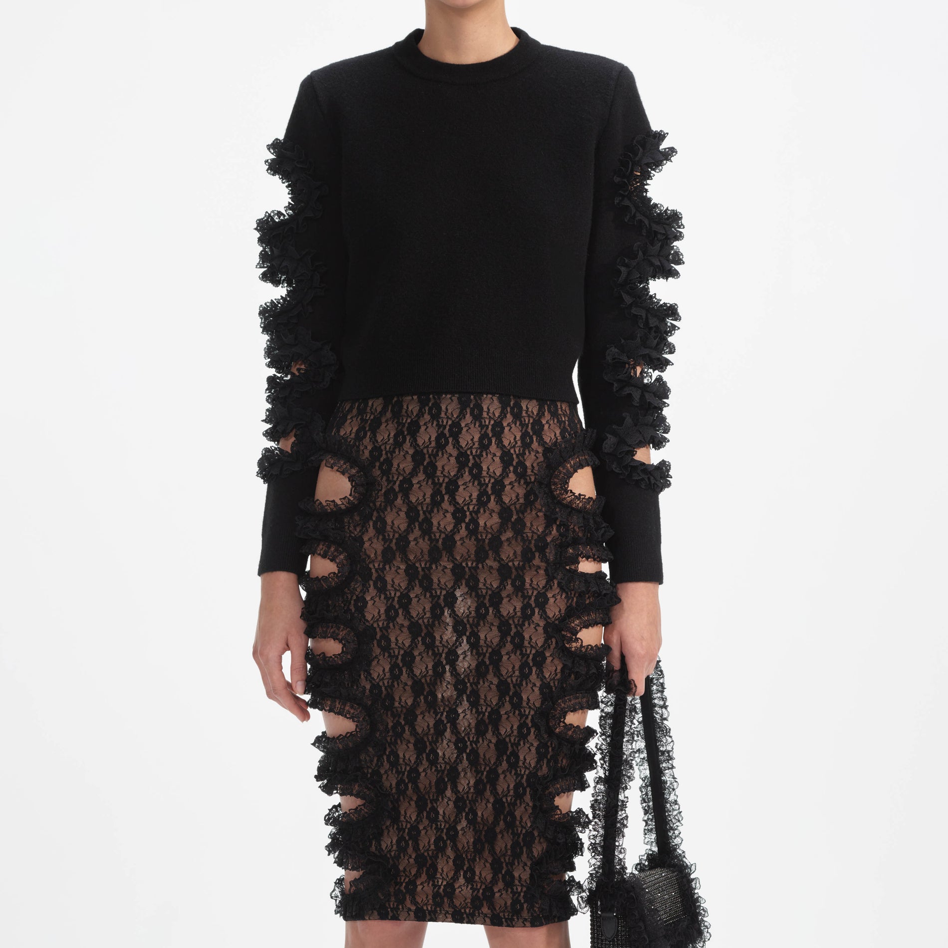 A close up of a woman wearing the Black Cut Out Lace Detail Jumper