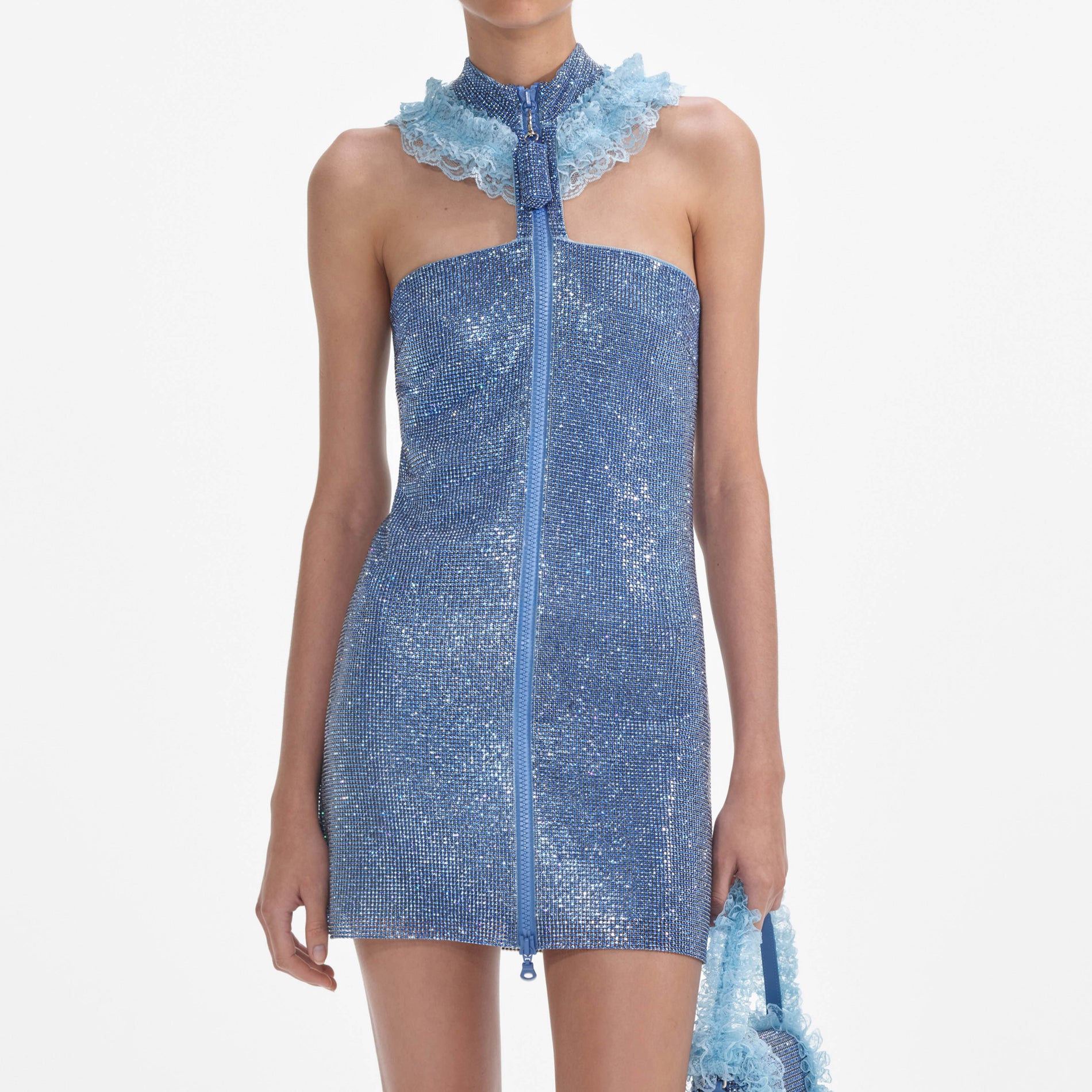A close up of a woman wearing the Blue Crystal Chainmail Zip Mini Dress