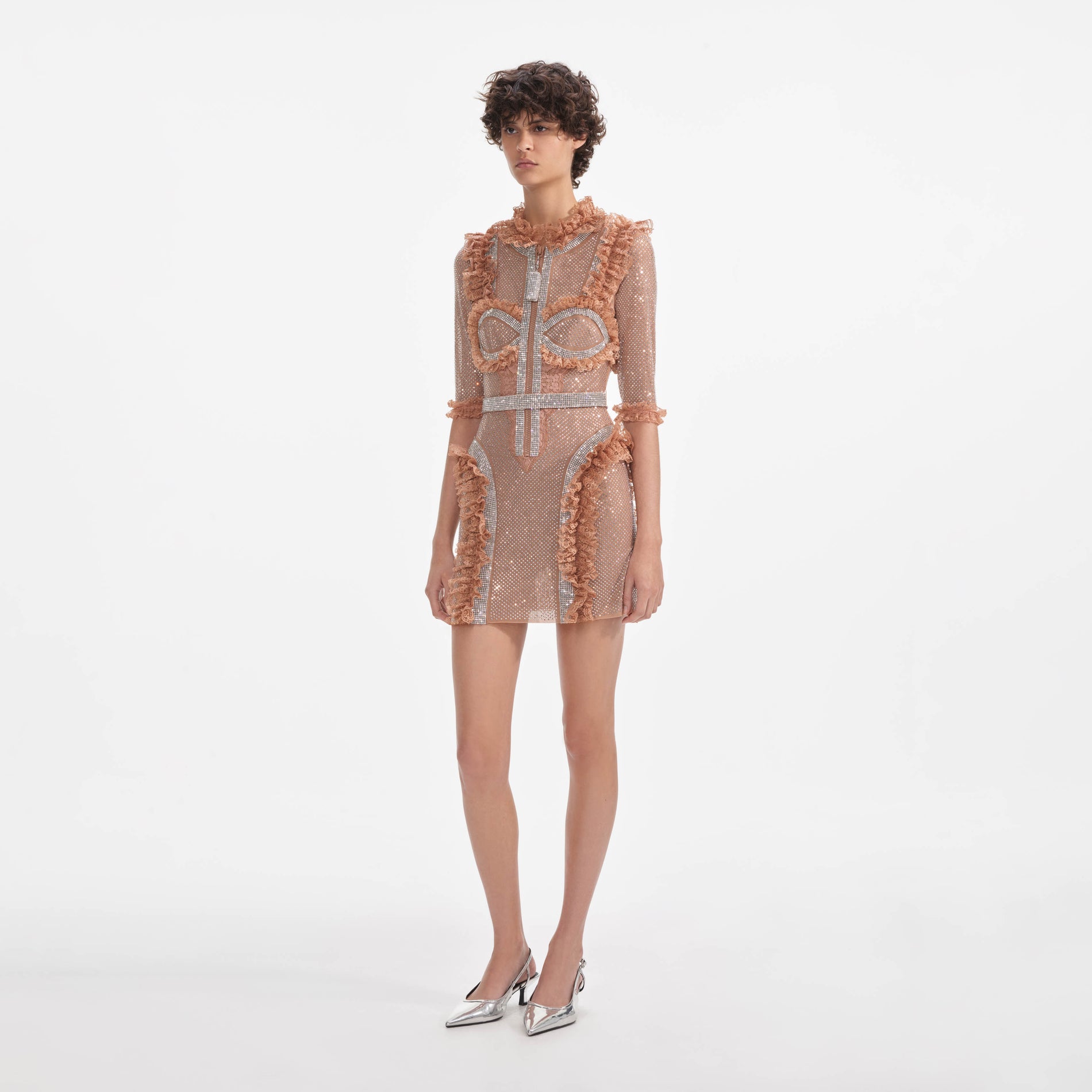 Side view of a woman wearing the Tan Rhinestone Mesh Ruffle Mini Dress