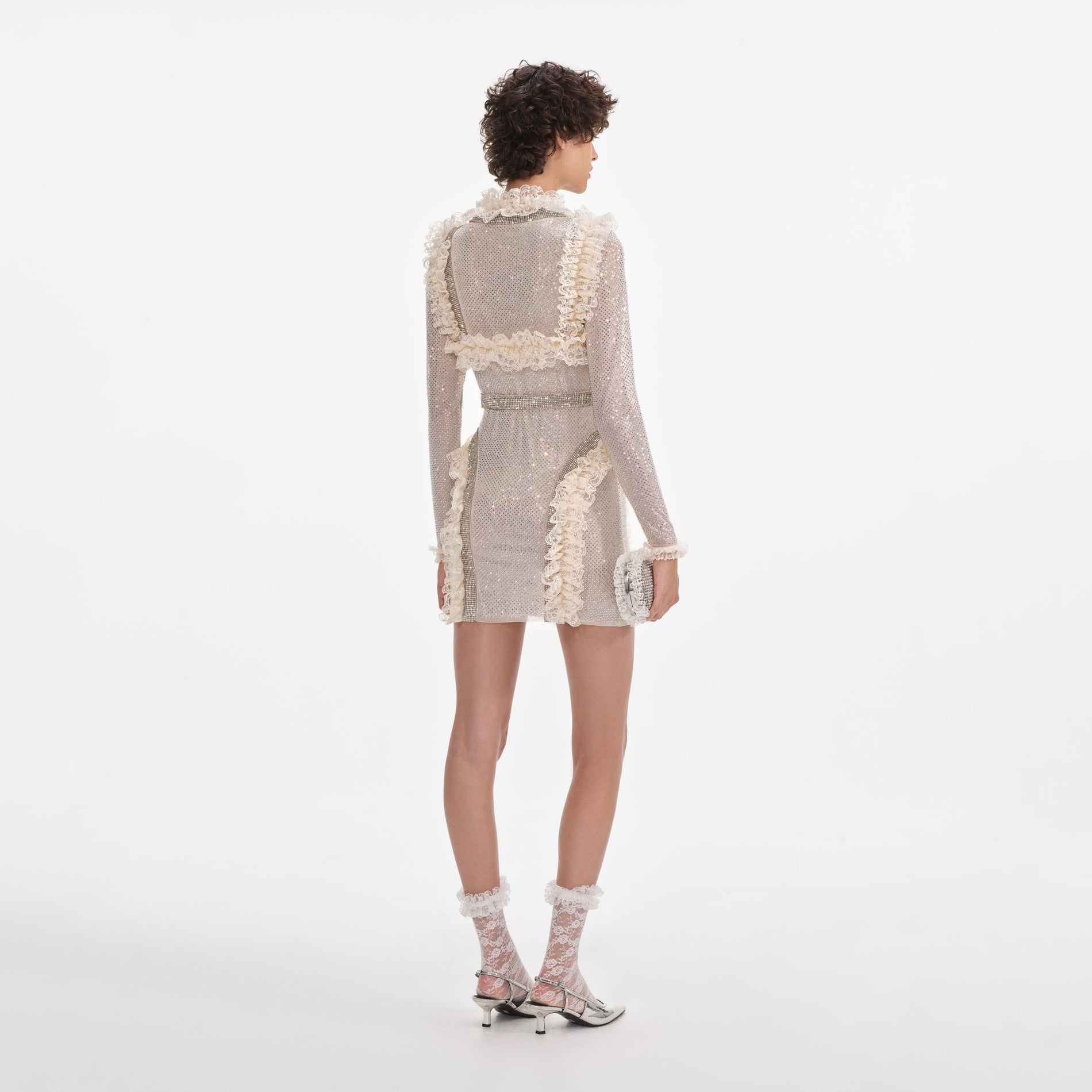 Back view of a woman wearing the Cream Rhinestone Mesh Ruffle Mini Dress