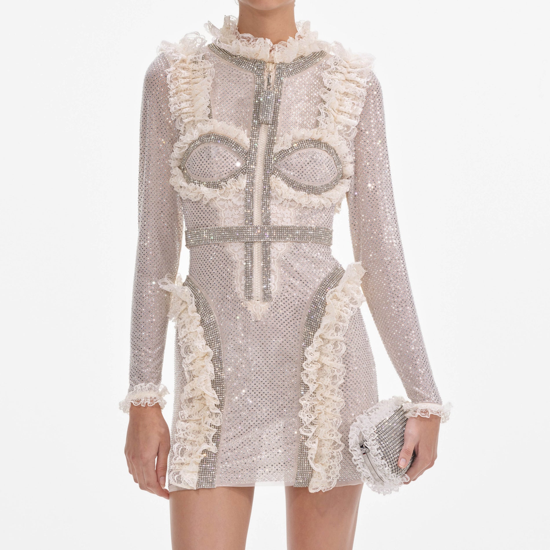A close up of a woman wearing the Cream Rhinestone Mesh Ruffle Mini Dress