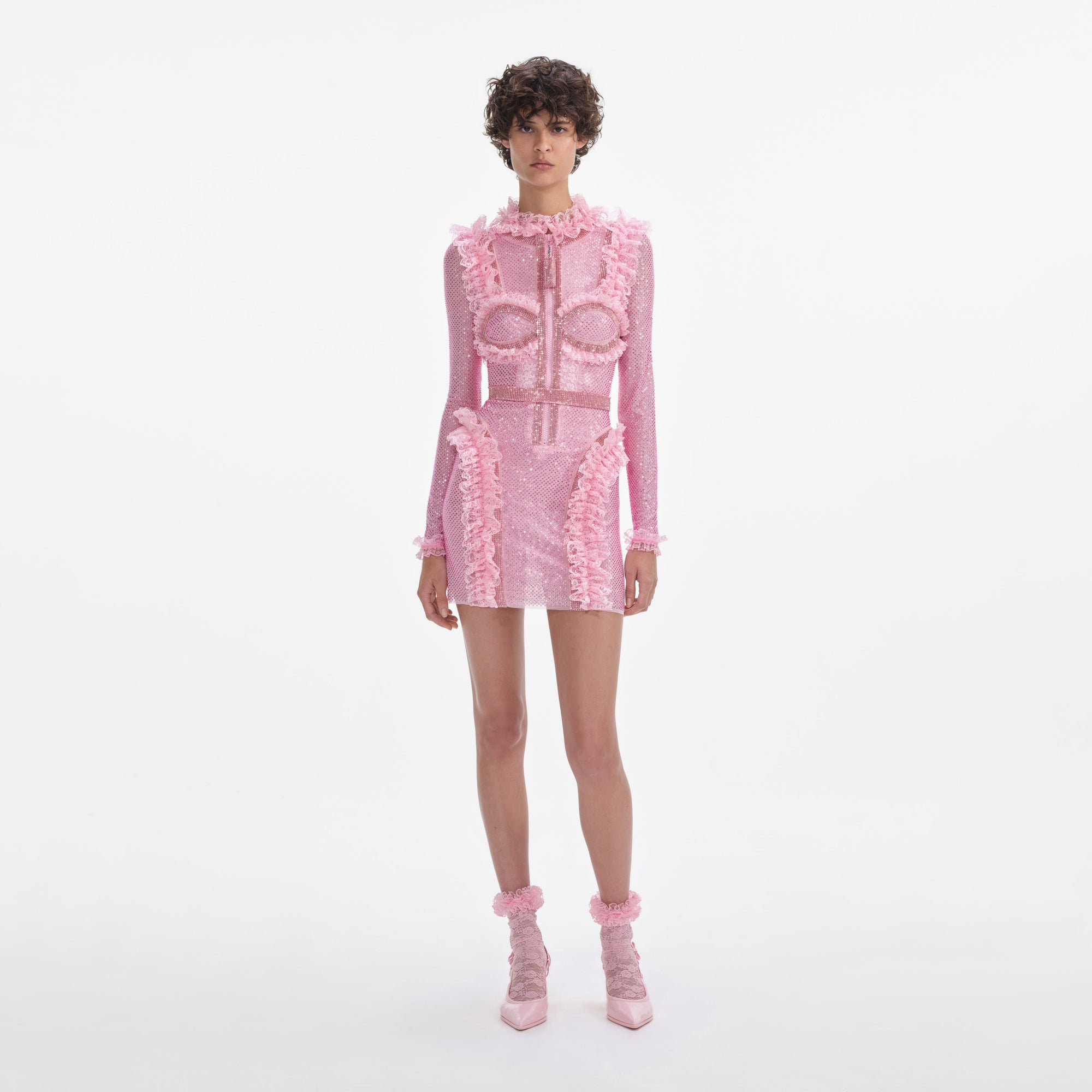 Front view of a woman wearing the Pink Rhinestone Mesh Ruffle Mini Dress