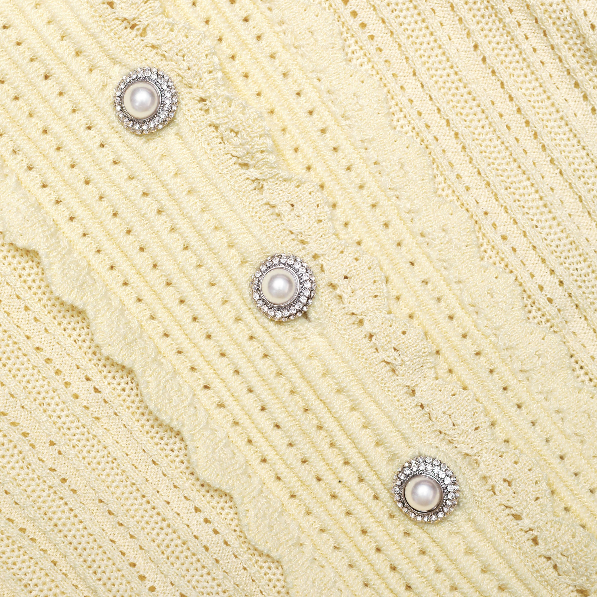 A close up of the fabric for the Yellow Pointelle Cardigan